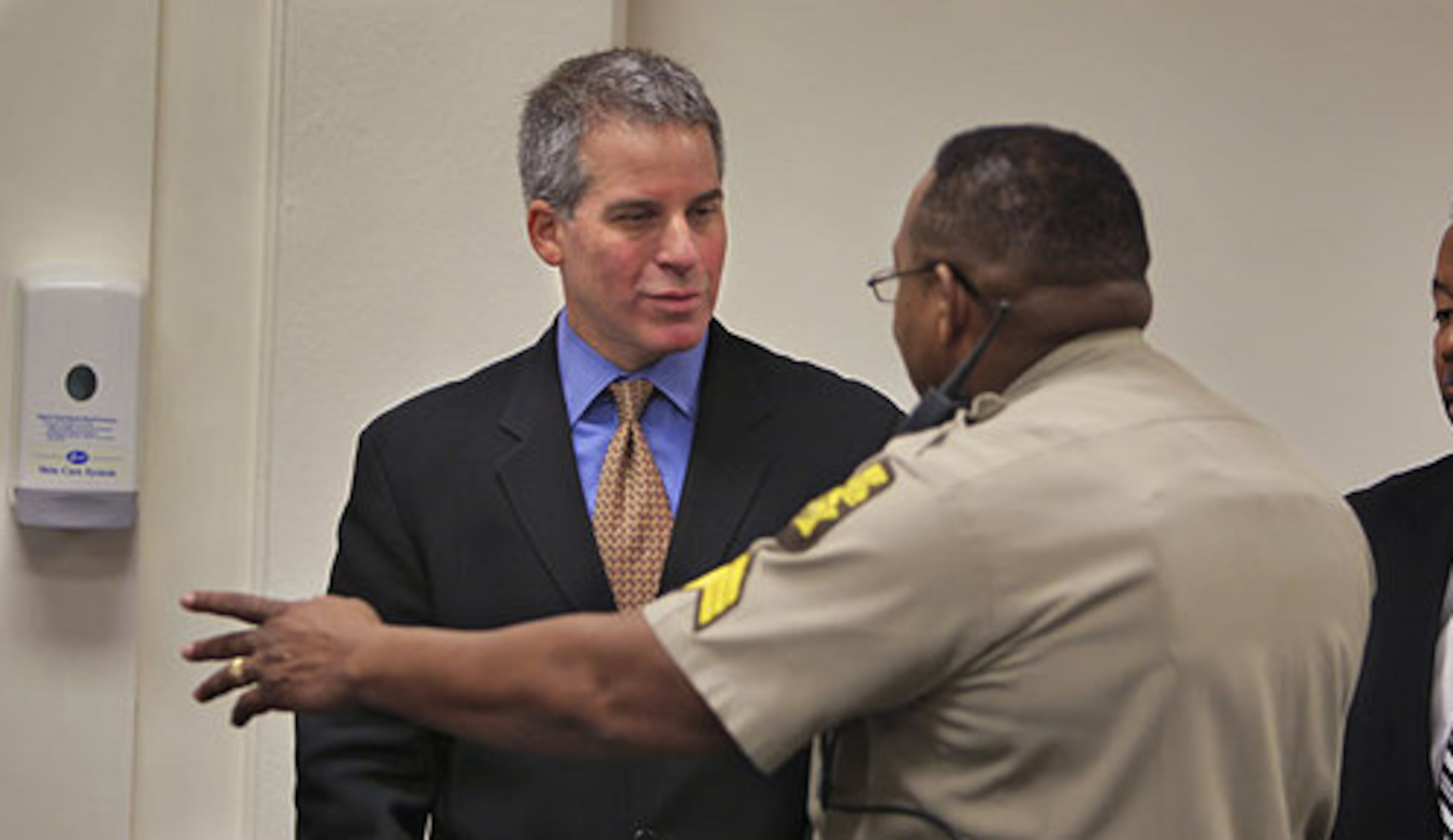 Attorney Brian Steel (left) talks with Fulton County Sheriff Sgt. E. S. Davis following the waive of the hearing Friday. The former Georgia Tech star was held more than two weeks in Los Angeles and returned to Atlanta on Thursday night to face charges that he shot and killed a mother of four.