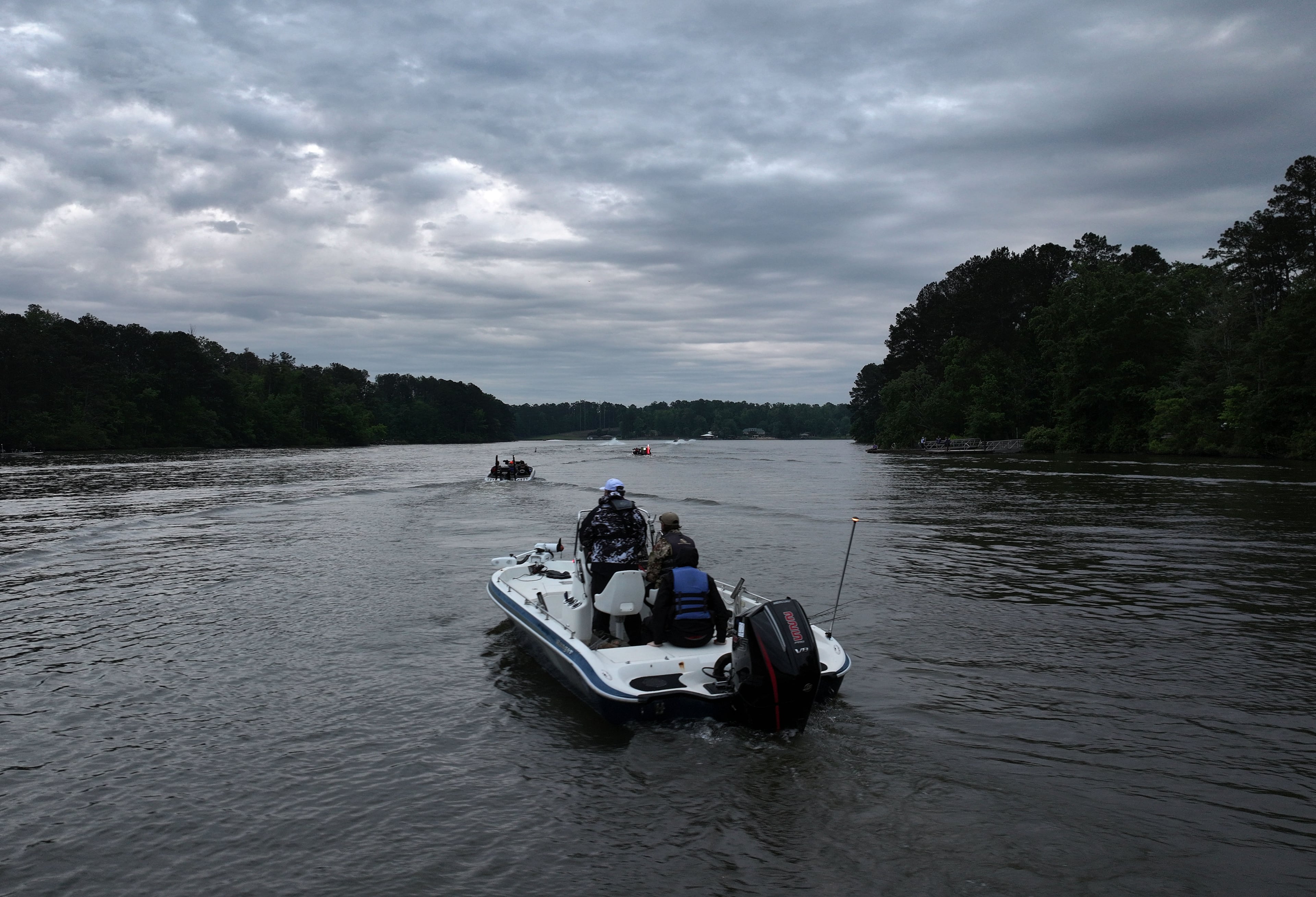 The sun starts to rise as student anglers and their coaches head out on the Lake Sinclair during the GHSA State Bass Fishing Championship on Saturday, May 9, 2026. (Hyosub Shin/AJC)