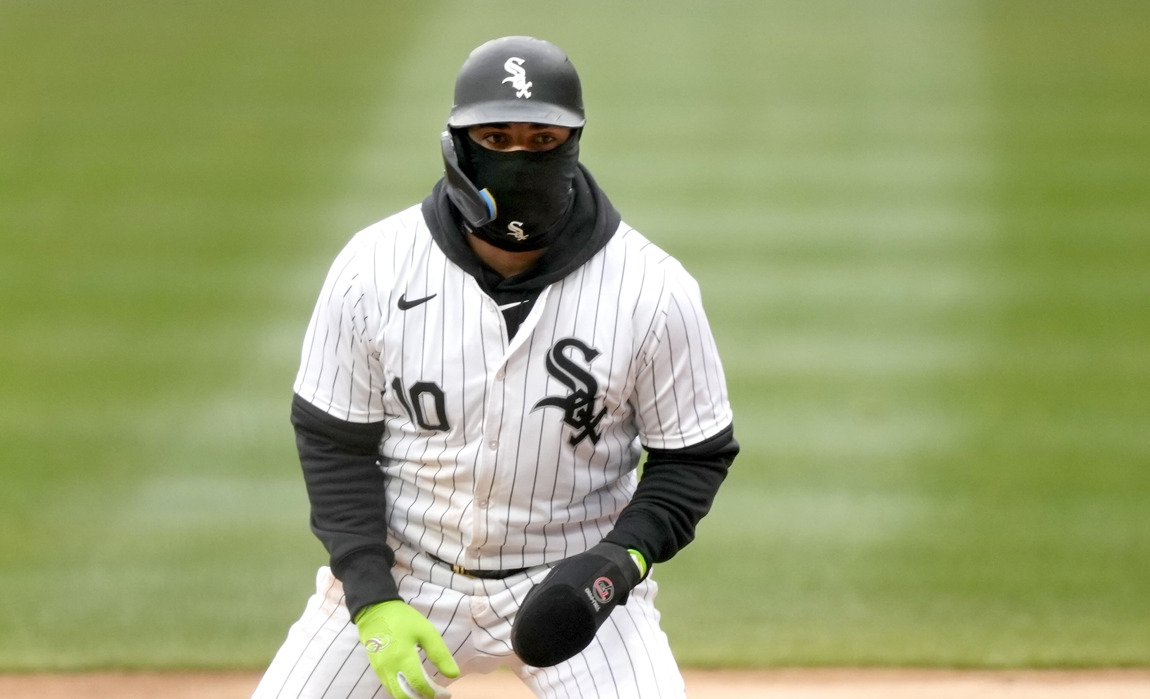 Chicago's Yoan Moncada wears a balaclava to keep the cold wind off his face as he takes a short lead off first base during Monday's home game against the Braves.