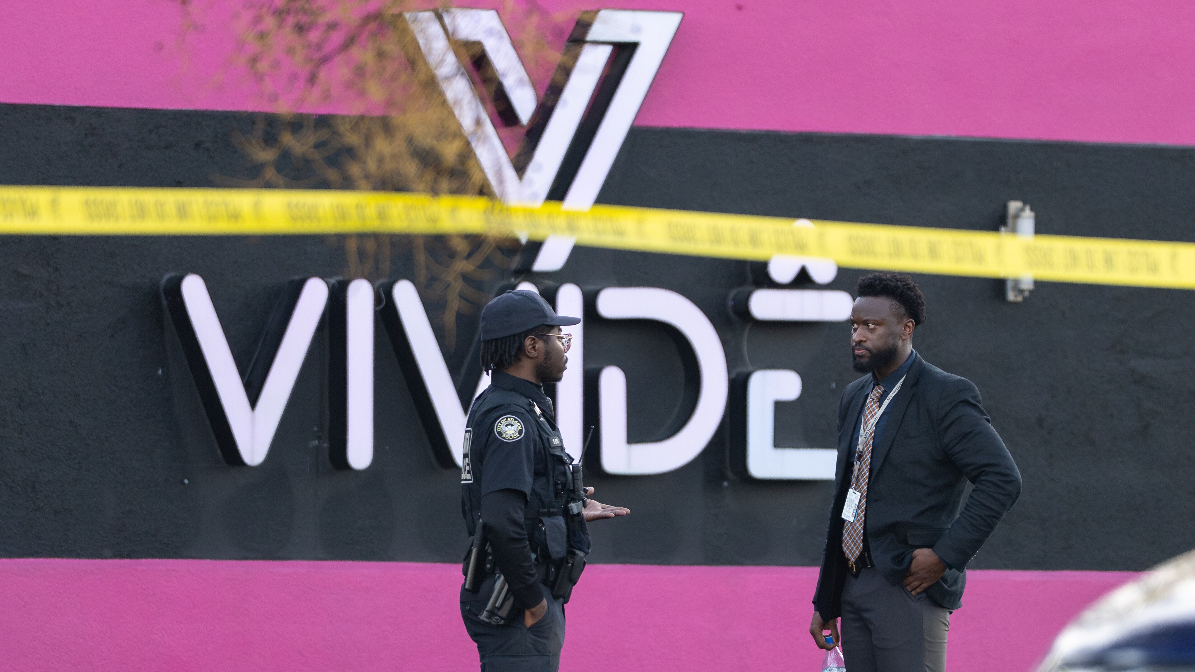 An Atlanta police officer and detective stand in the parking lot of the Vivide nightclub on Marietta Boulevard following a fatal stabbing early Wednesday, Nov. 26, 2025, in Blandtown. (Ben Hendren for the AJC)