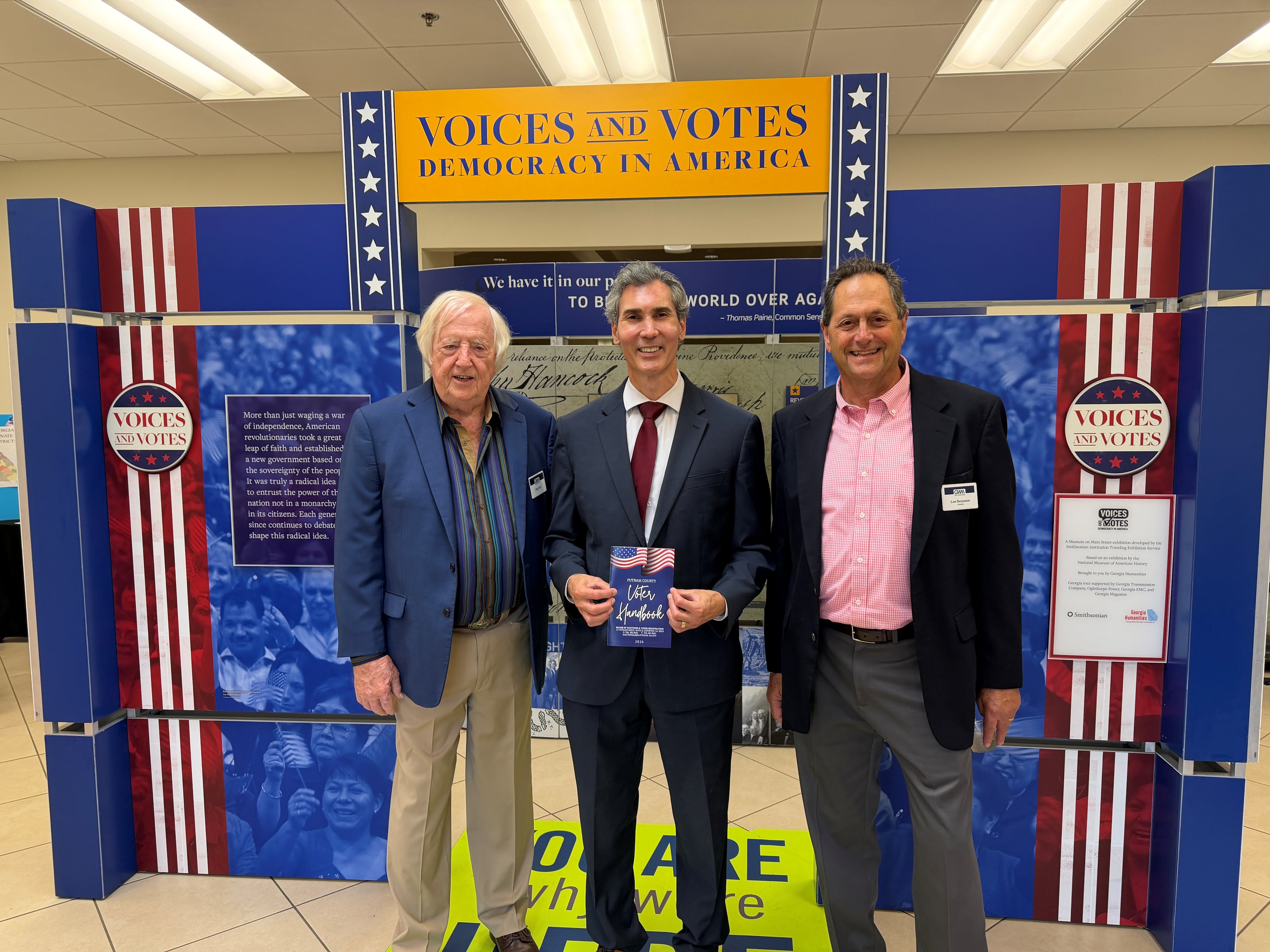 AJC Opinion Editor David Plazas (center) stands with Georgia Writers Museum board member Chip Ward (left) and board president Lou Benjamin (right) at the inaugural "Voices and Votes: Democracy in America" exhibit in Eatonton, Georgia on April 25, 2026.