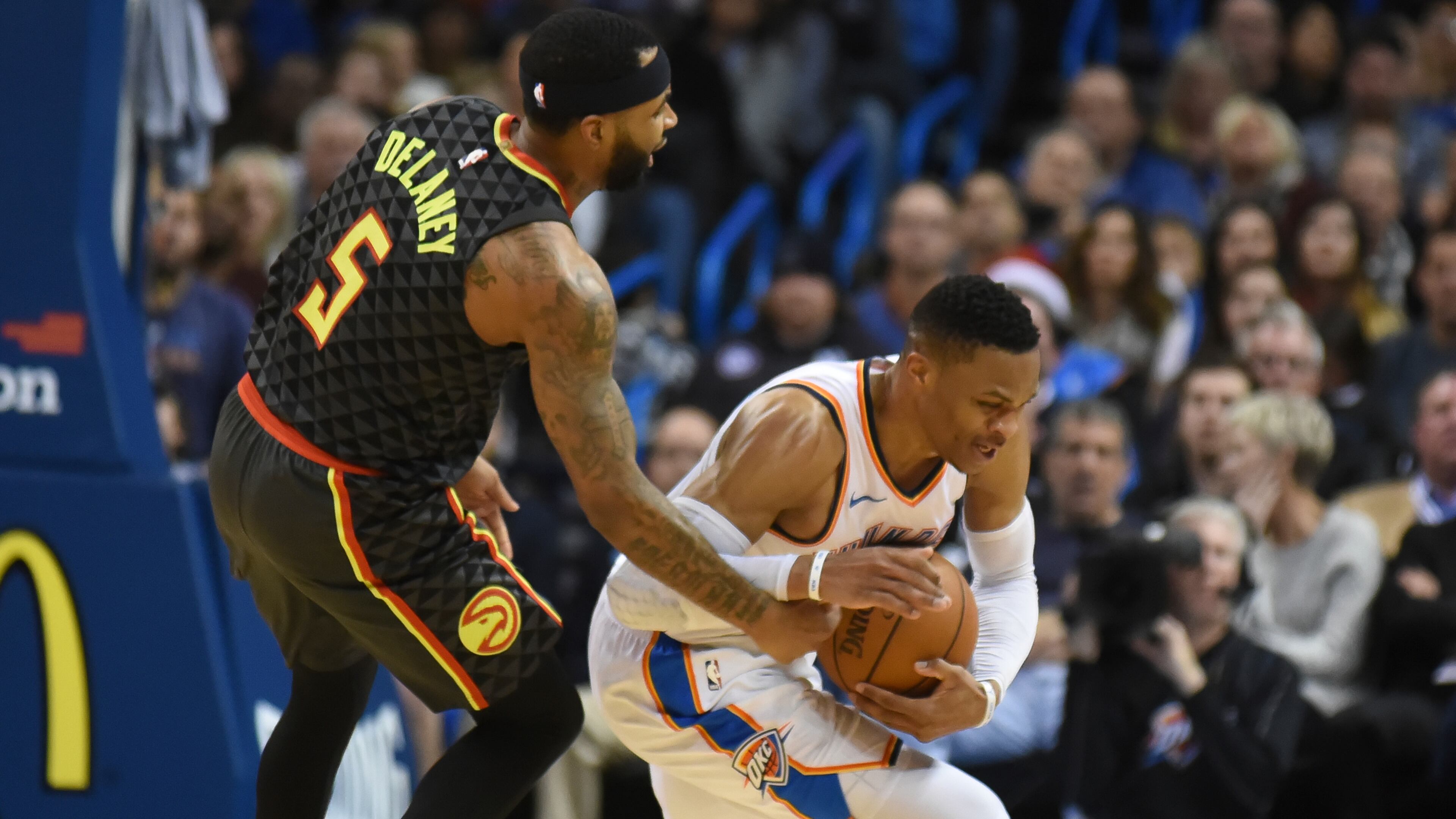 Hawks' Malcolm Delaney, left, tries to get the ball away from Oklahoma City's Russell Westbrook, right, in the third quarter of an NBA basketball game in Oklahoma City, Friday, Dec. 22, 2017. (AP Photo/Kyle Phillips)