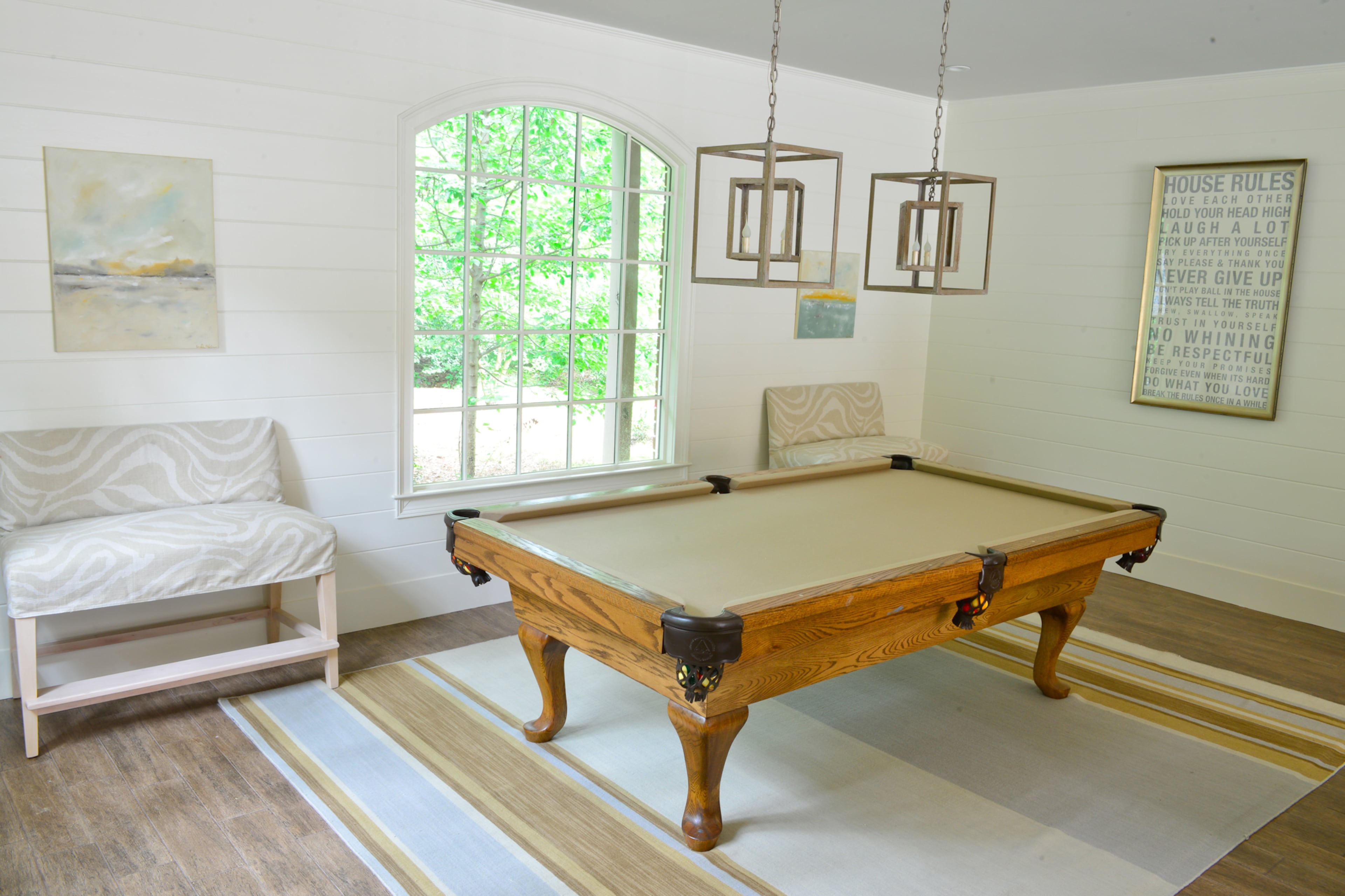A contemporary pool table fits the style of the pool room's interior. Artwork around the pool table includes two acrylics by California artist Linda Donahue. -- Text by Lori Johnston