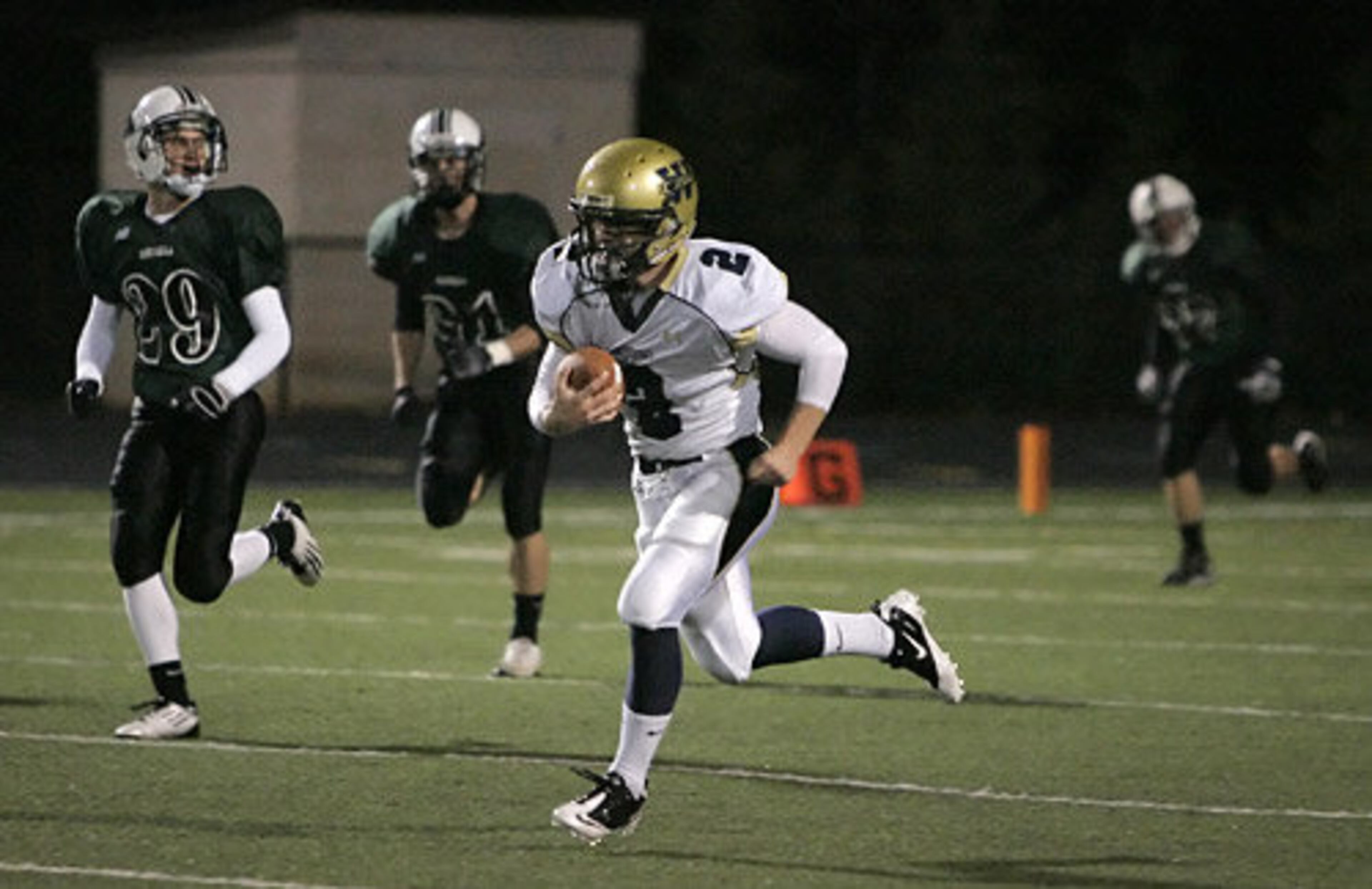 West Forsyth wide receiver Graham Bunting (2) runs for a long gain as Roswell defensive back Alex Brandeis (29) and cornerback Matt Semple pursue during the first quarter of their high school football game, Friday, Oct. 28, 2011.
