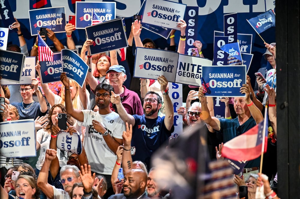 Members of the audience cheer as U.S. Sen. Jon Ossoff walks on stage at a rally last month in Savannah. (Sarah Peacock for the AJC)