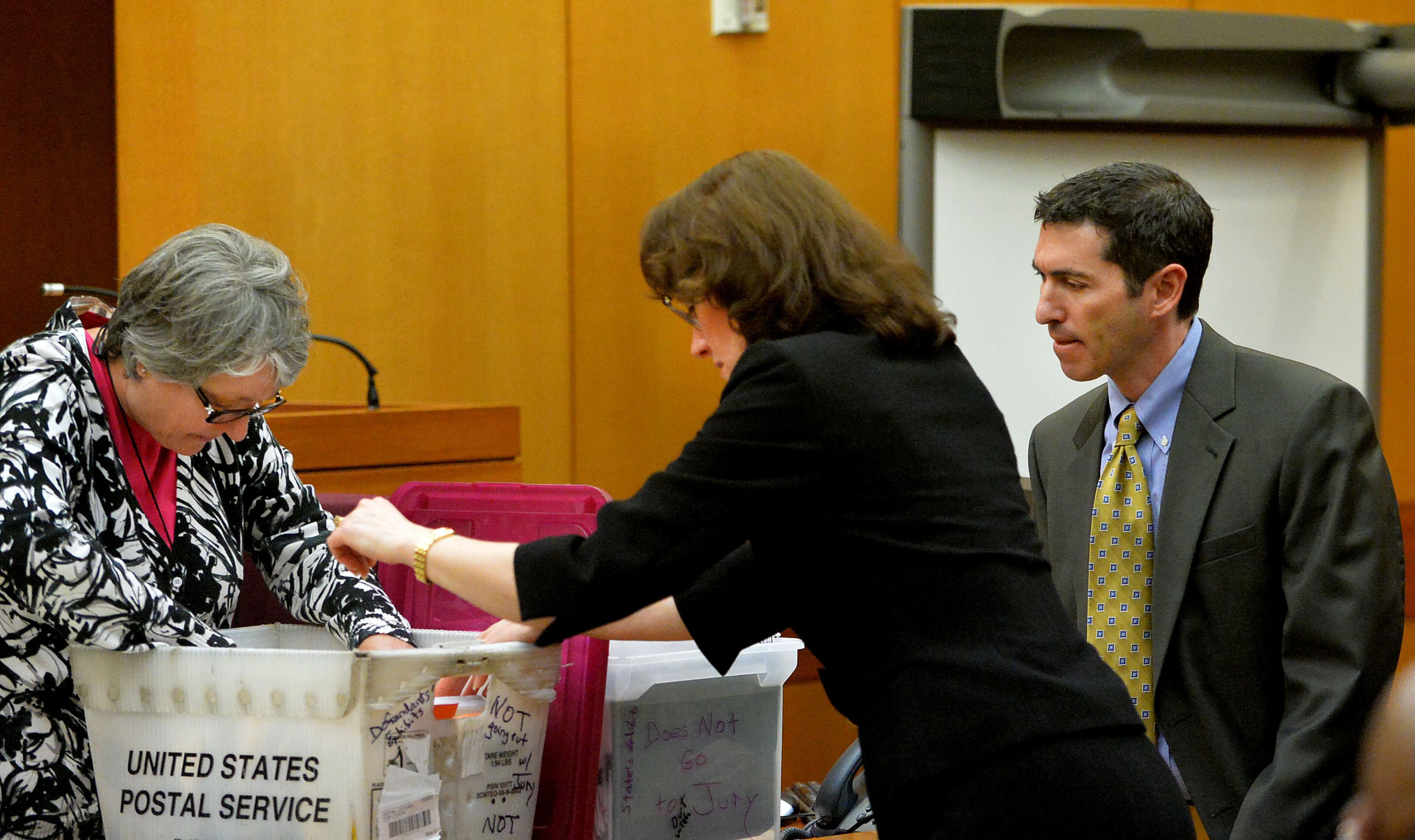 Court reporter Evelyn Parker, Fulton County Deputy DA Linda Dunikoski and defense attorney Sanford Wallack look for a piece of evidence requested by the jury Thursday in the Atlanta Public Schools test-cheating trial. (Atlanta Journal-Constitution, Kent D. Johnson, Pool)