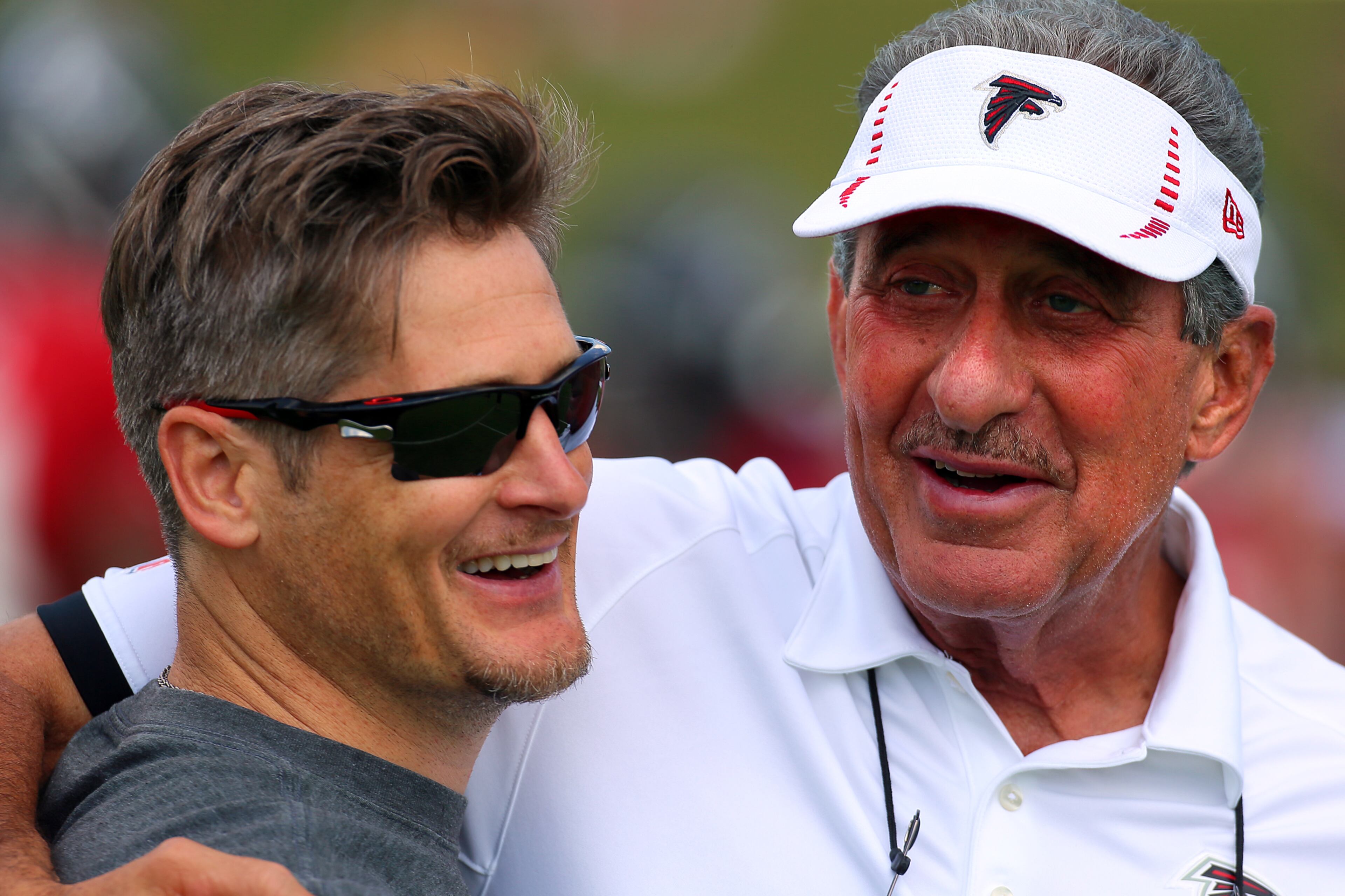 Falcons GM Thomas Dimitroff and Blank share a laugh on the first day of practice after signing Matt Ryan to a five-year extension on July 25, 2013, in Flowery Branch.