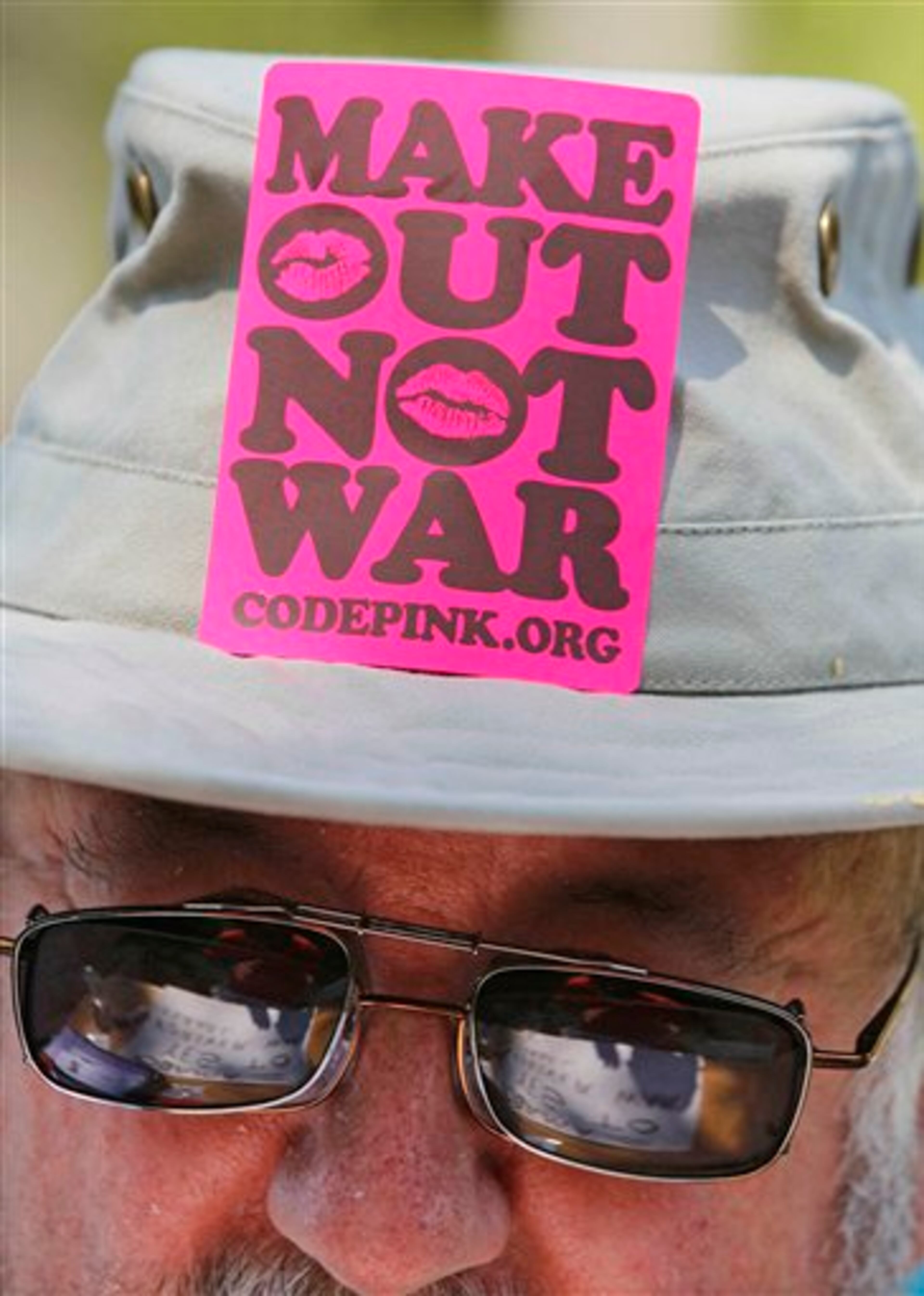 Bill Fisk, of Henderson, N.C. works on protest signs during a rally, Sunday, Sept. 2, 2012, in Charlotte, N.C. Demonstrators are protesting and marching before the Democratic National Convention. (AP Photo/Gerry Broome)