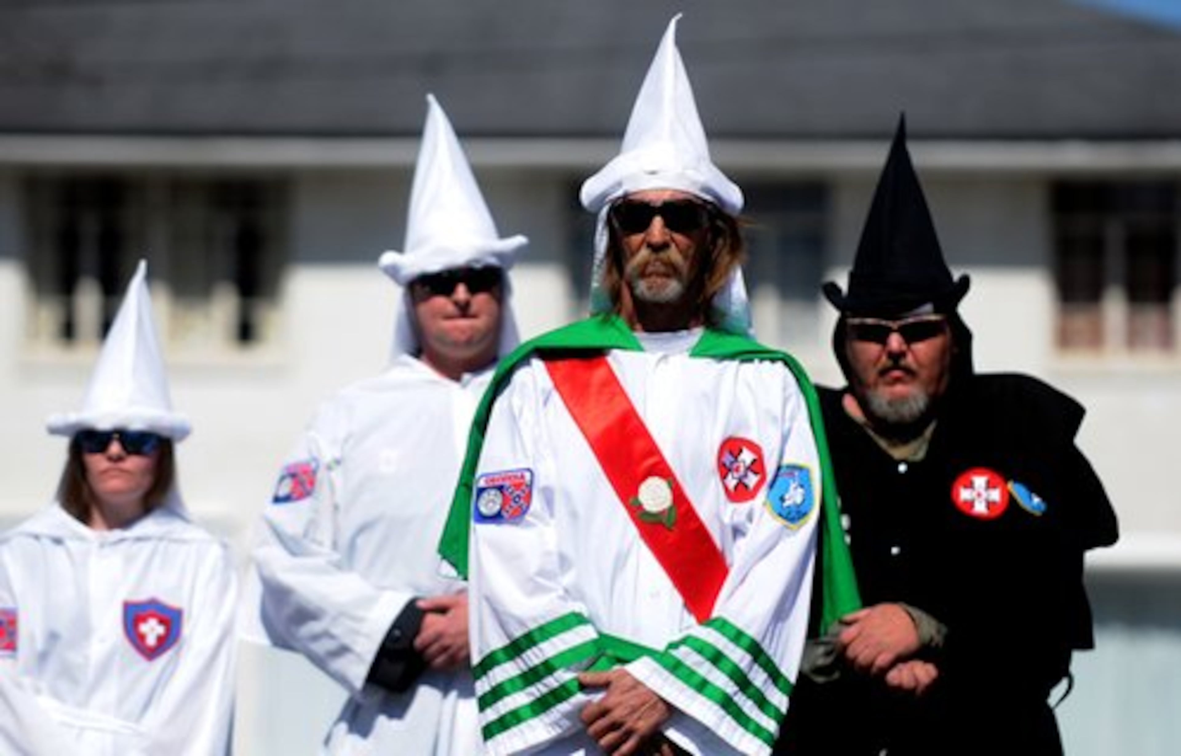 The Knight Riders Knights of the Ku Klux Klan stand in unison behind Imperial Wizard Jeff Jones.