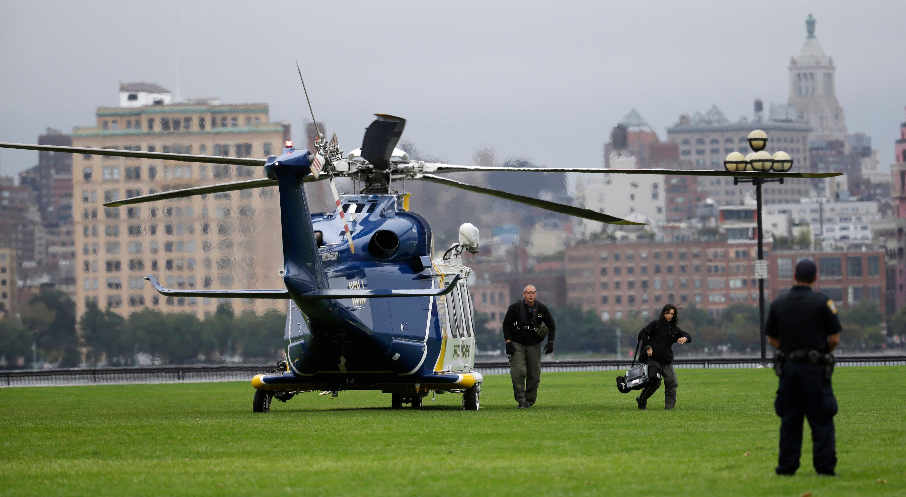 Emergency officials arrive by helicopter at Pier A Park near the Hoboken Terminal following a train crash, Thursday, Sept. 29, 2016, in Hoboken, N.J. A commuter train crashed into the rail station during the morning rush hour, causing serious damage. (AP Photo/Julio Cortez)