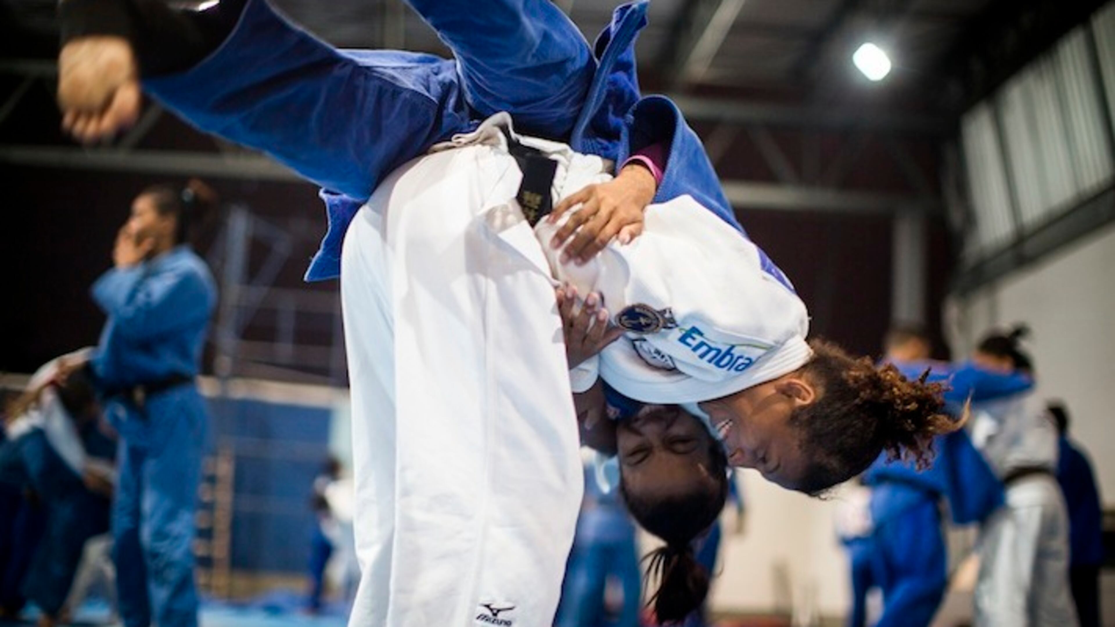 Rafaela Silva, in white, who grew up in the Cidade de Deus (City of God) slums of Rio de Janeiro, spars at a gym in the city, where she began training in judo as a child, Nov. 12, 2015. Silva, who was disqualified from the 2012 London Olympics but was World Champion in the sport in 2013, will compete in this summer's Olympics in Rio. (Leslye Davis/The New York Times)