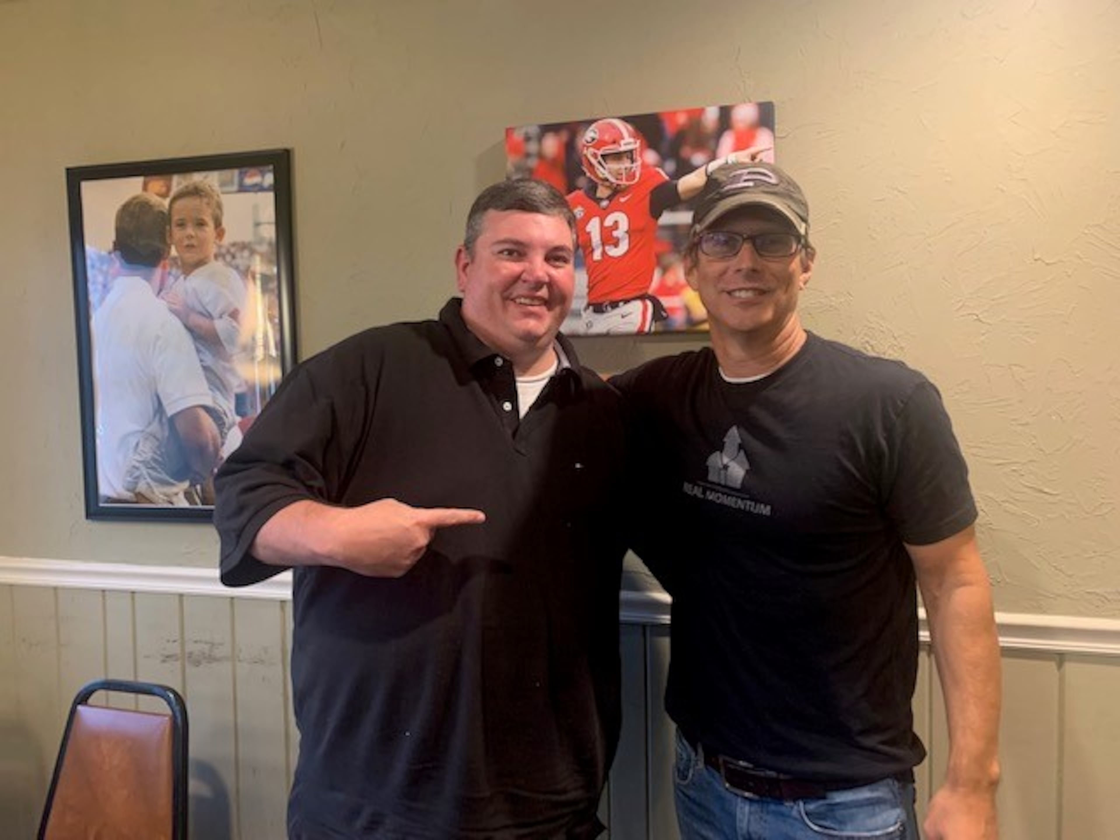 Stetson Bennett III (right) and Michael Morgan (left), former recreational director in Brantley County, inside the Oak Plaza restaurant in Blackshear, Ga., home of Georgia starting quarterback Stetson Bennett IV. Pictures on the wall are of the future quarterback.