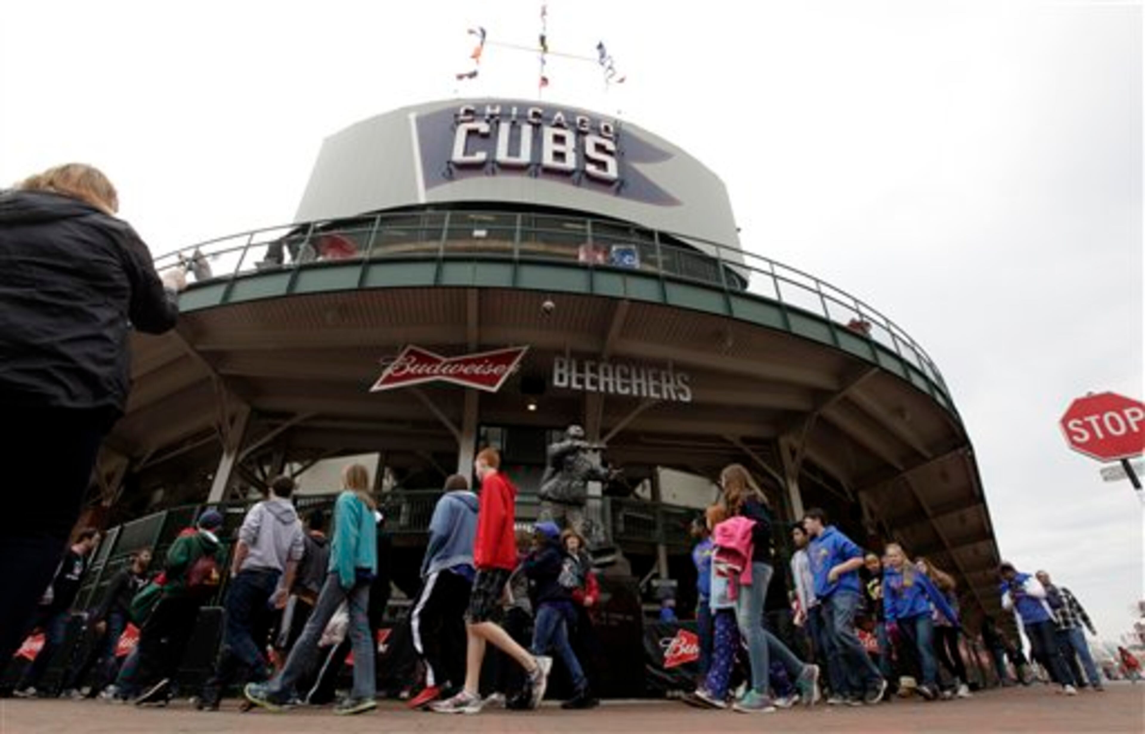 In this April 10, 2014 photo, fans arrive at Wrigley Field before a baseball game between Pittsburgh Pirates and Chicago Cubs, in Chicago. Wrigley Field will host its 100th anniversary celebration as the Chicago Cubs host the Arizona Diamondbacks on Wednesday, April 23, 2014, exactly one century after the Chicago Federals opened then-Weeghman Park against the Kansas City Packers. (AP Photo/Kiichiro Sato)