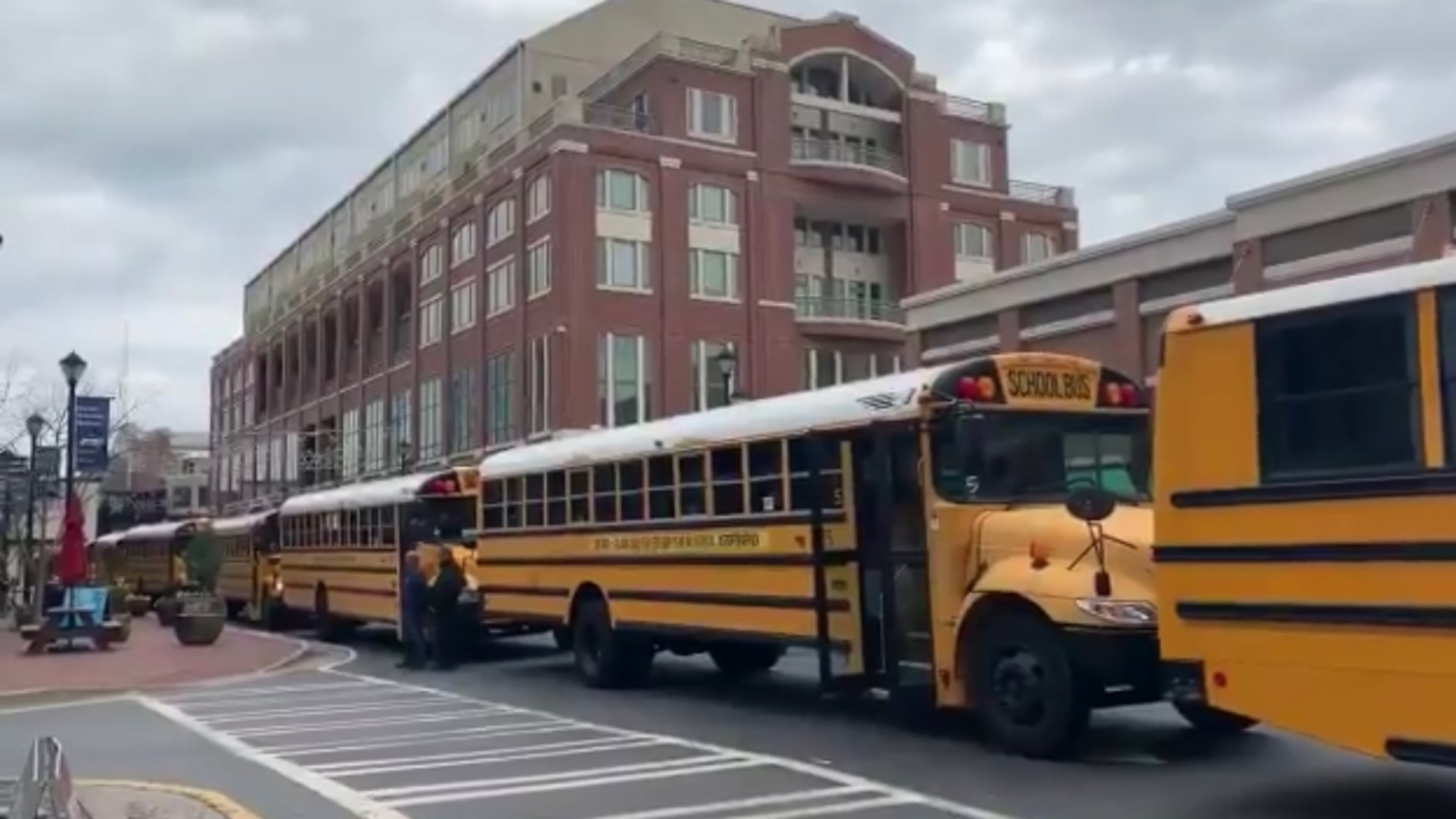 A group of 72 school buses featuring anti-sex trafficking messages created a mile-long moving billboard along Atlanta’s streets on Wednesday. AJC photo.