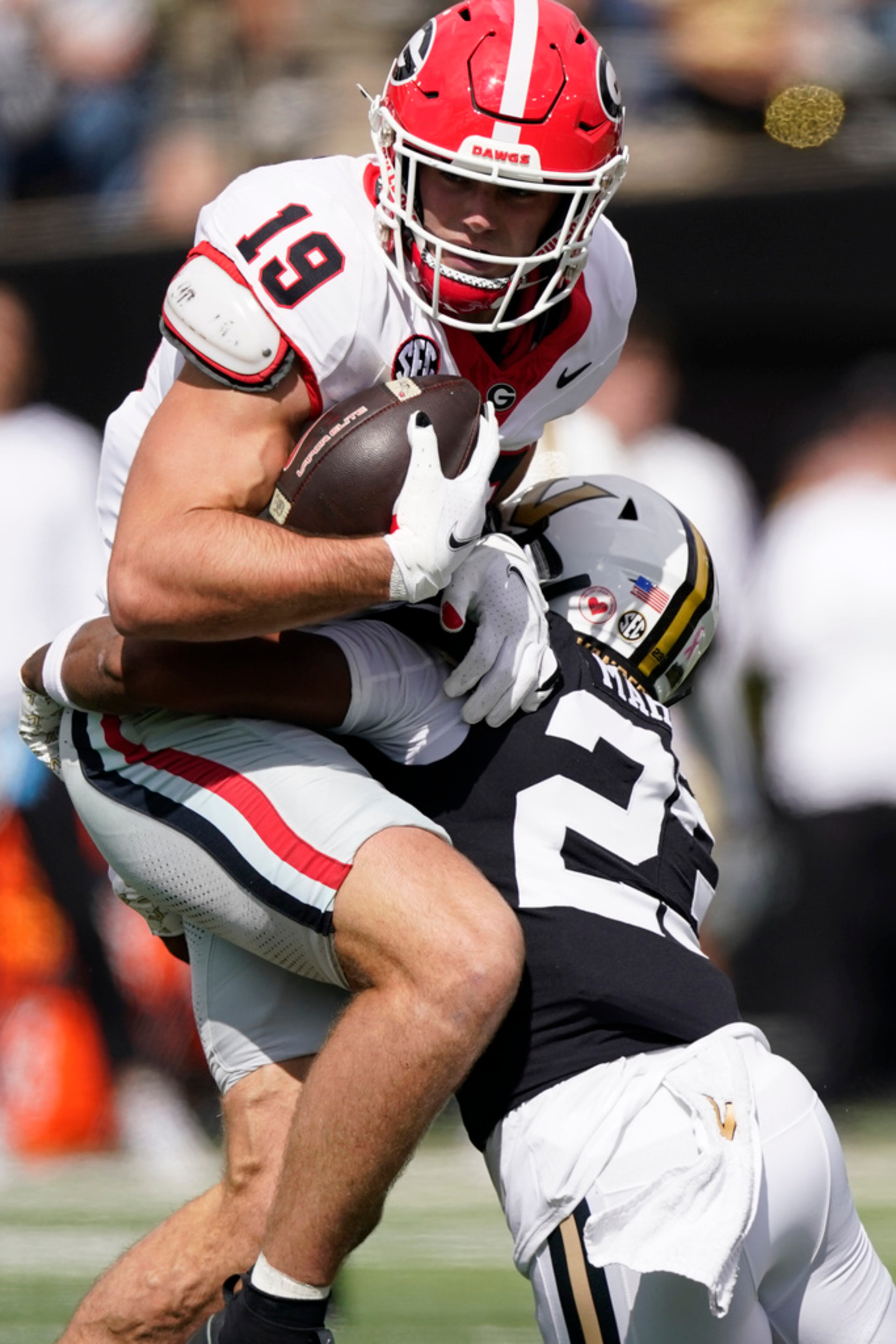 Georgia tight end Brock Bowers (19) is tackled by Vanderbilt defensive back Jaylen Mahoney (23) after a catch in the first half of an NCAA college football game Saturday, Oct. 14, 2023, in Nashville, Tenn. (AP Photo/George Walker IV)