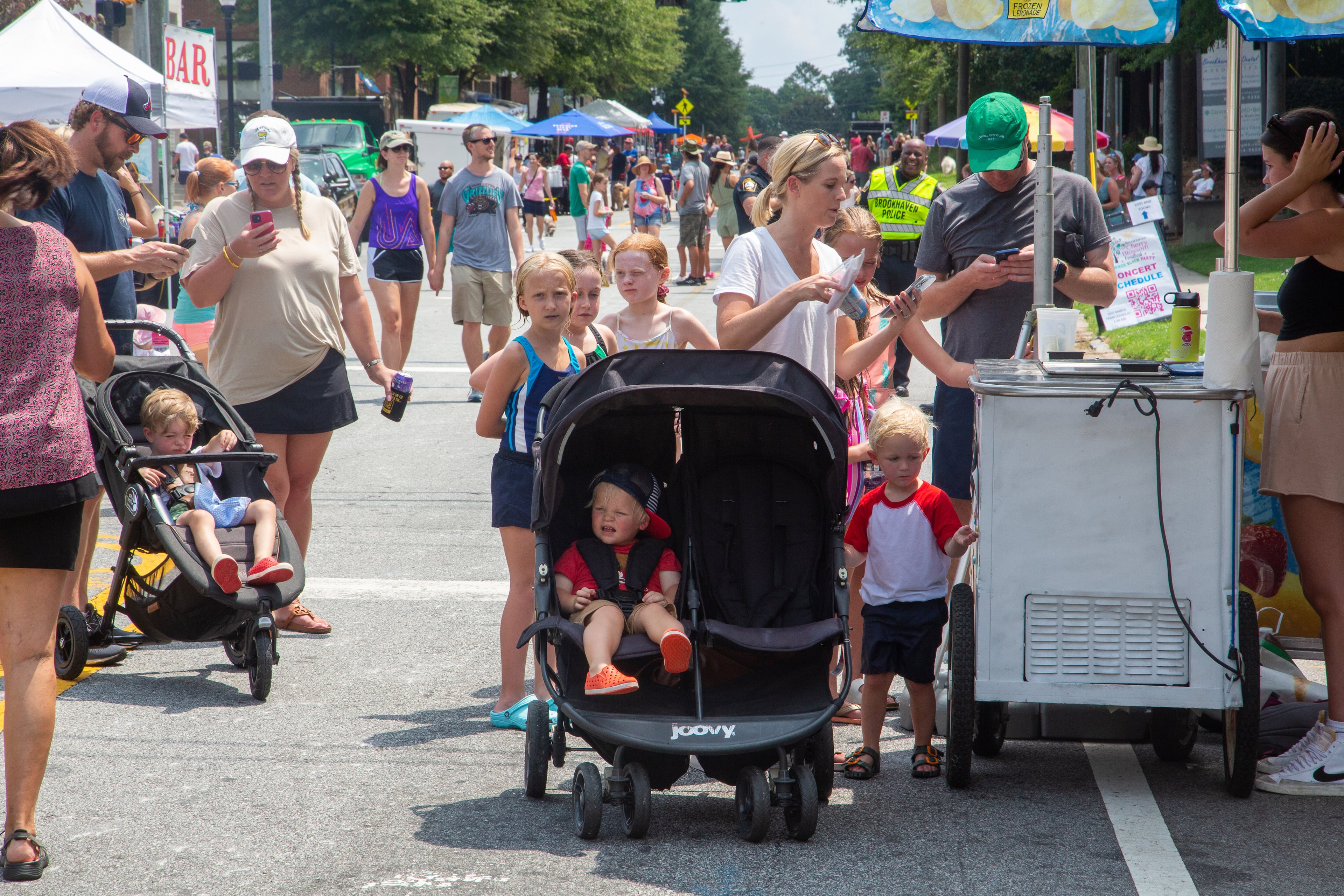People line up for ice cream along Dresden Drive during the Brookhaven Cherry Blossom Festival on Saturday, July 31, 2021. STEVE SCHAEFER FOR THE ATLANTA JOURNAL-CONSTITUTION