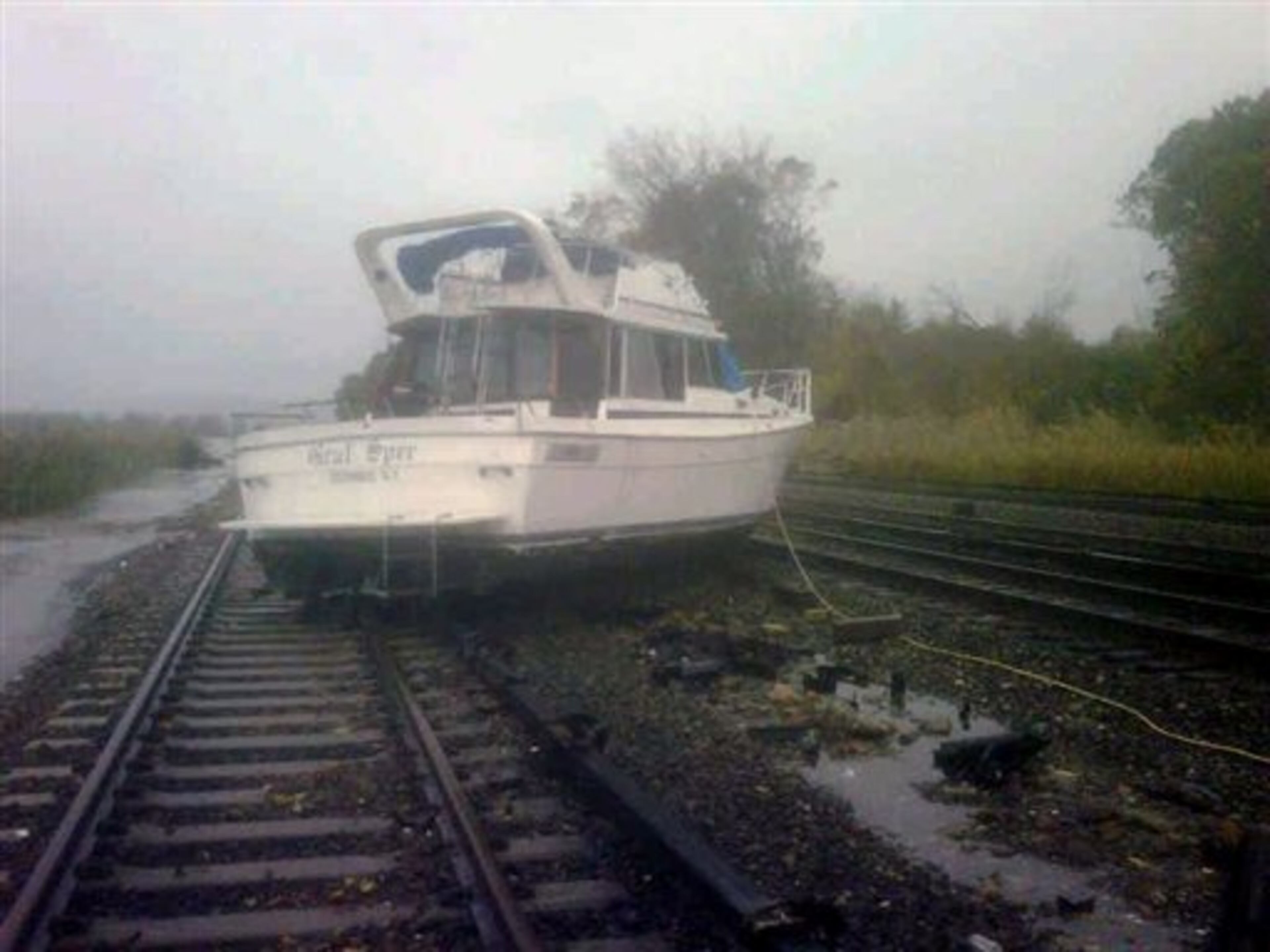 This photo provided by the Metropolitan Transportation Authority of the State of New York shows a boat resting on the tracks at Metro-North's Ossining Station in the aftermath of Hurricane Sandy on Tuesday, Oct. 30, 2012, in Ossining,N.Y. Sandy, the storm which was downgraded from a hurricane just before making landfall, caused multiple fatalities, halted mass transit and cut power to more than 6 million homes and businesses. (AP Photo/Metropolitan Transportation Authority of the State of New York) MANDATORY CREDIT