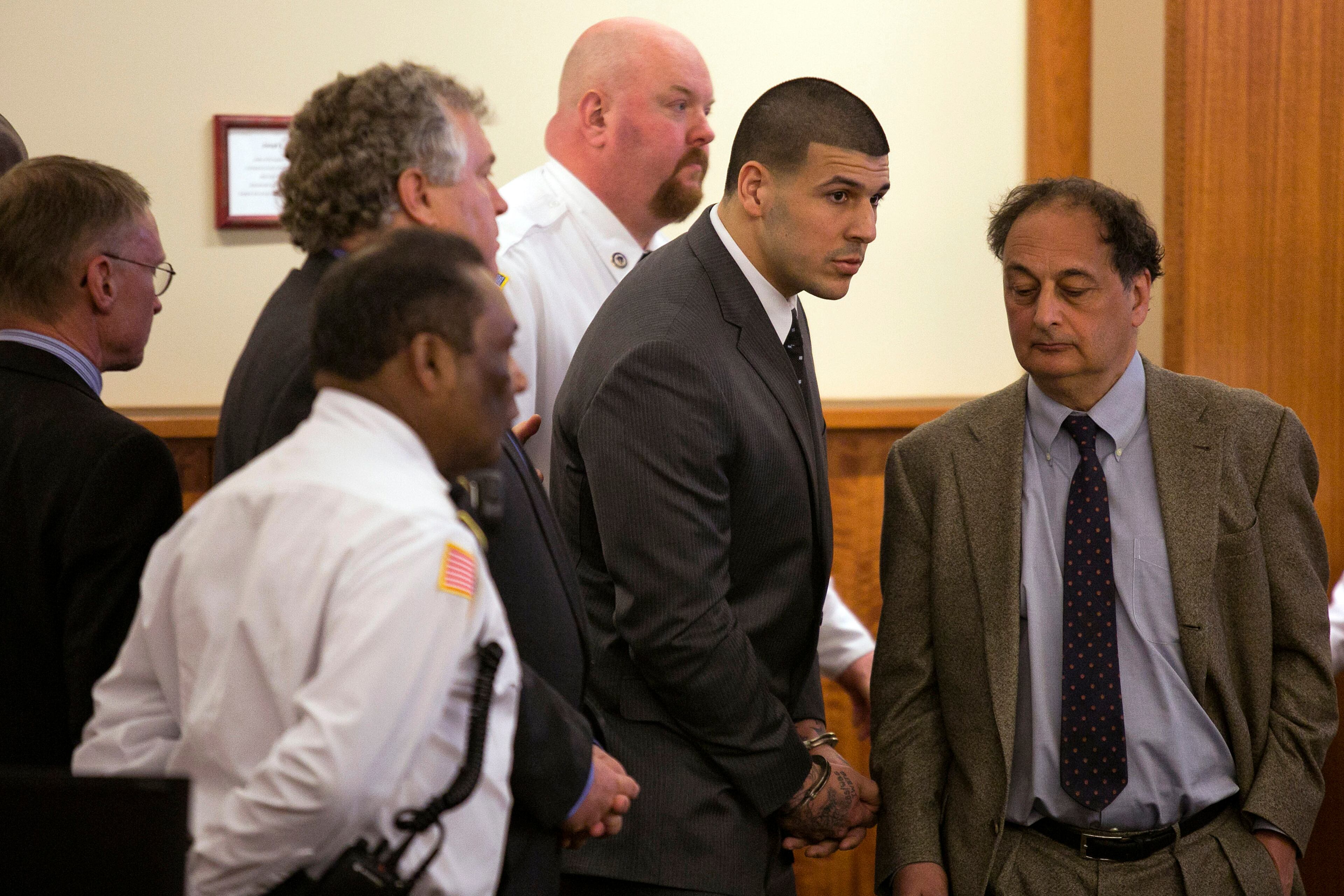 Former New England Patriots football player Aaron Hernandez stands up after he is sentenced to life in prison at his murder trial at the Bristol County Superior Court in Fall River, Mass., on Wednesday, April 15, 2015. Hernandez was found guilty of first-degree murder in the shooting death of Odin Lloyd in June 2013. (Dominick Reuter/Pool Photo via AP)