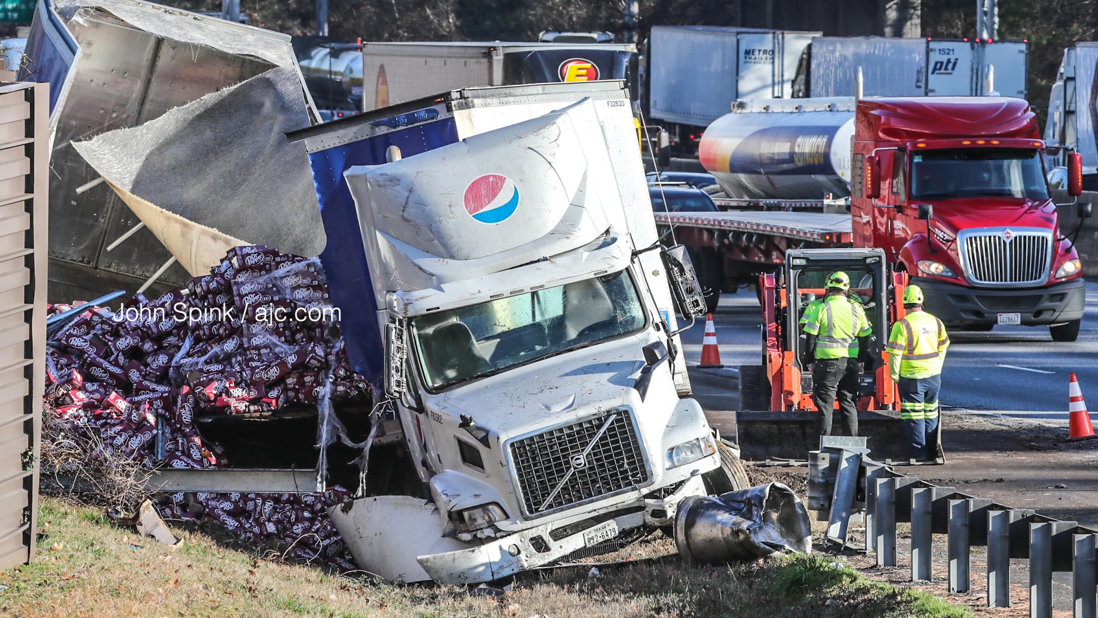 A Pepsi truck hauling cans of Dr Pepper slammed into a barrier wall on I-285 South at Paces Ferry Road early Tuesday morning.