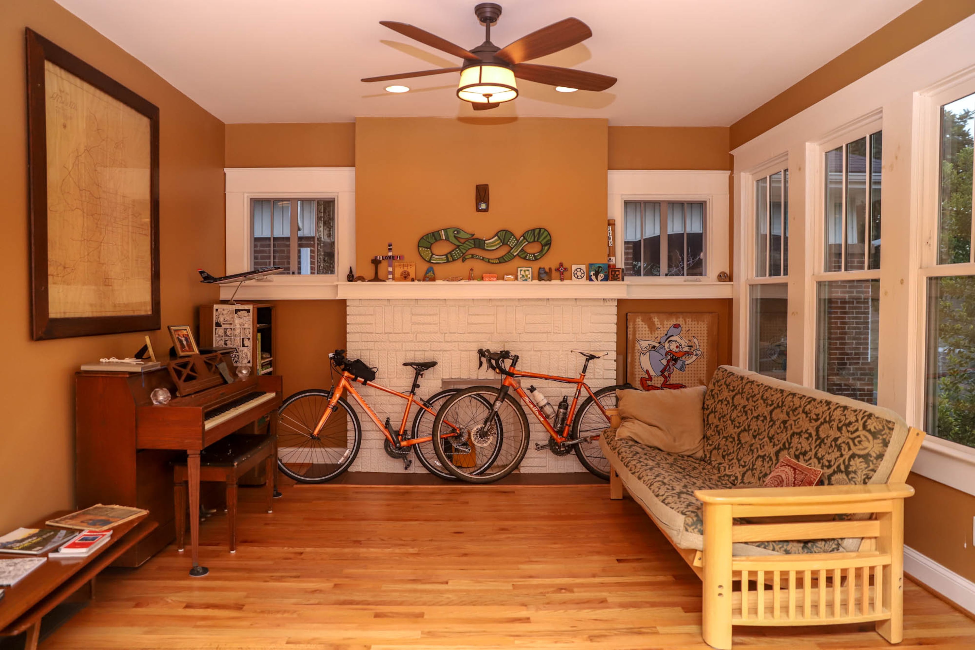 One of Angel Poventud's favorite features in his 1,200-square-foot bungalow are its 21 windows. The walls in the living room are painted Eastlake Gold, which is part of the Sherwin-Williams Historic Collection.
