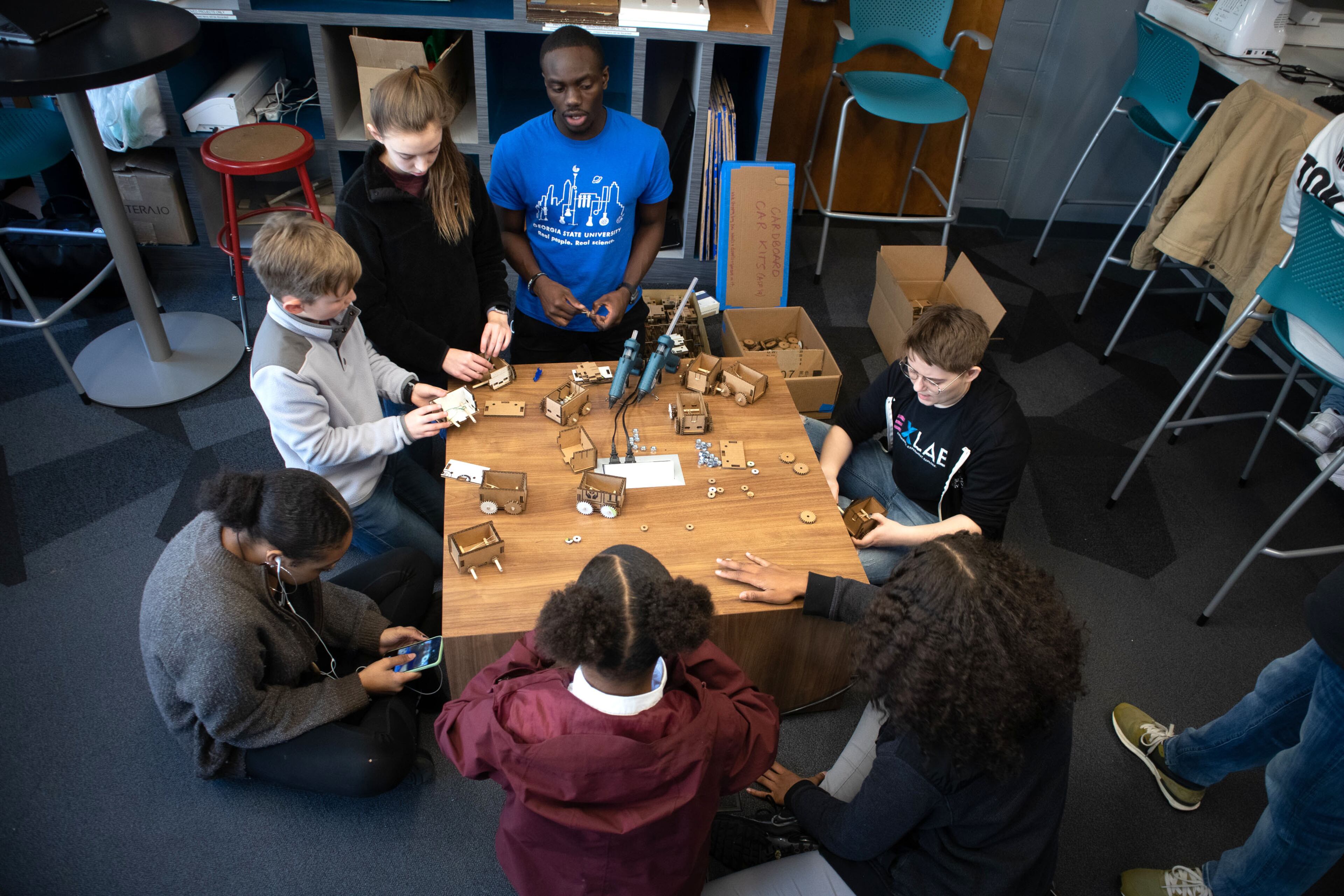 People assemble their rubberband power car projects during the Genius Camp in the ExLab at Georgia State University on Saturday, March 7, 2020. STEVE SCHAEFER / SPECIAL TO THE AJC