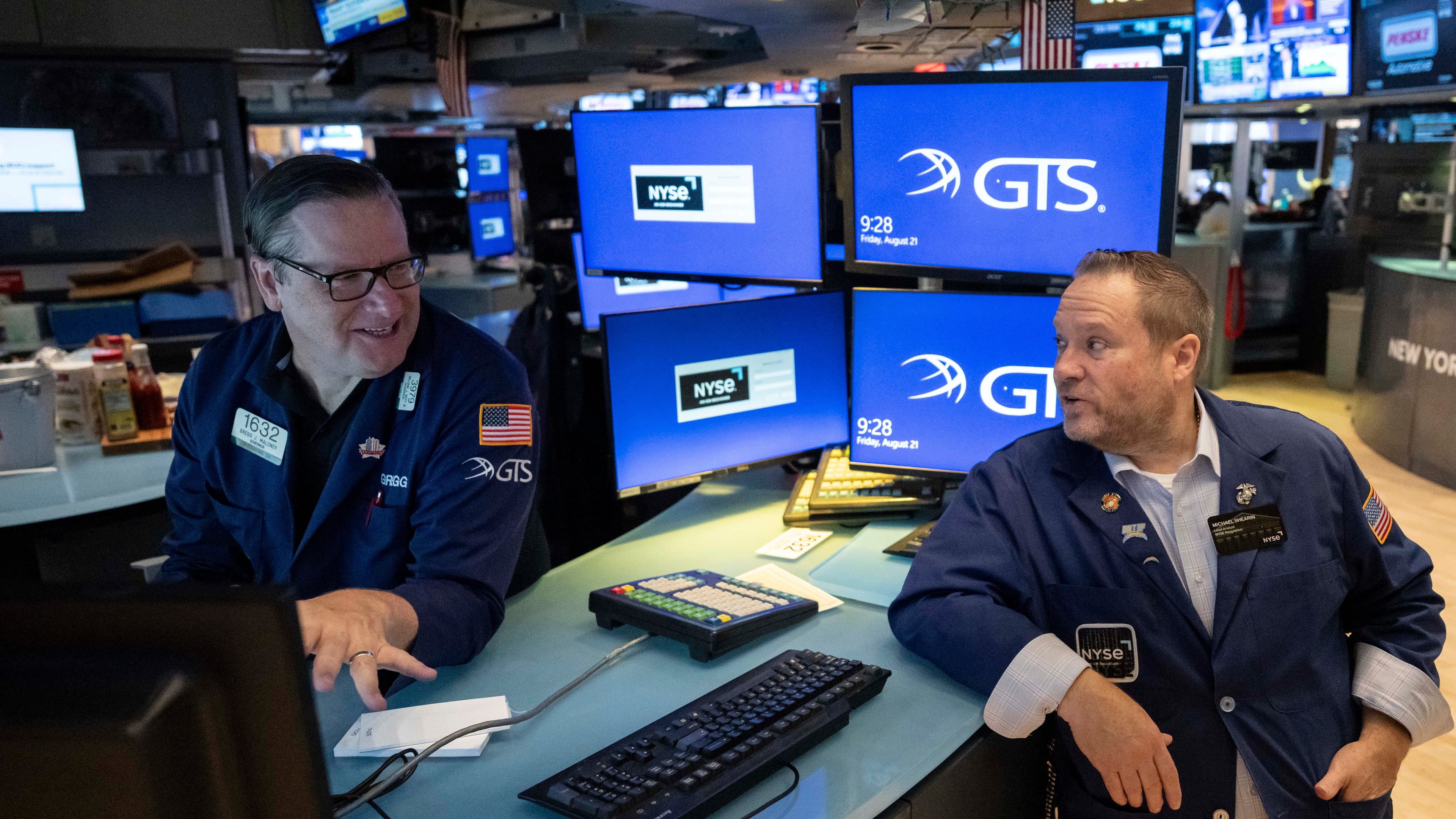 Specialists Gregg Maloney, left, and Michael Shearin work on the floor of the New York Stock Exchange in New York, Friday, Aug. 21, 2026. (AP Photo/Yuki Iwamura)