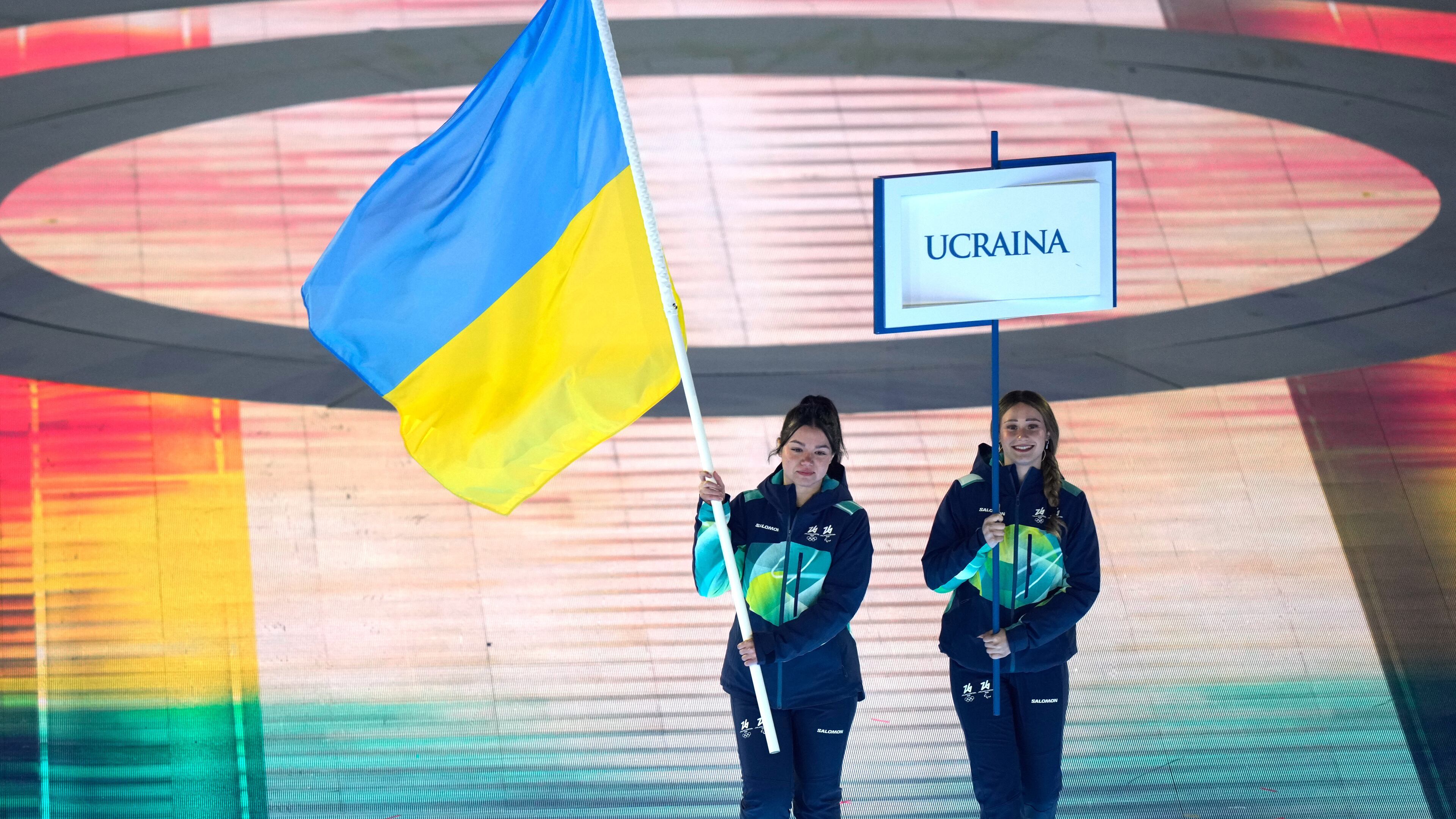 A volunteer holds the Ukrainian flag to take part in the opening ceremony at the 2026 Winter Paralympics, in Verona, Italy, Friday, March 6, 2026. (AP Photo/Luca Bruno)