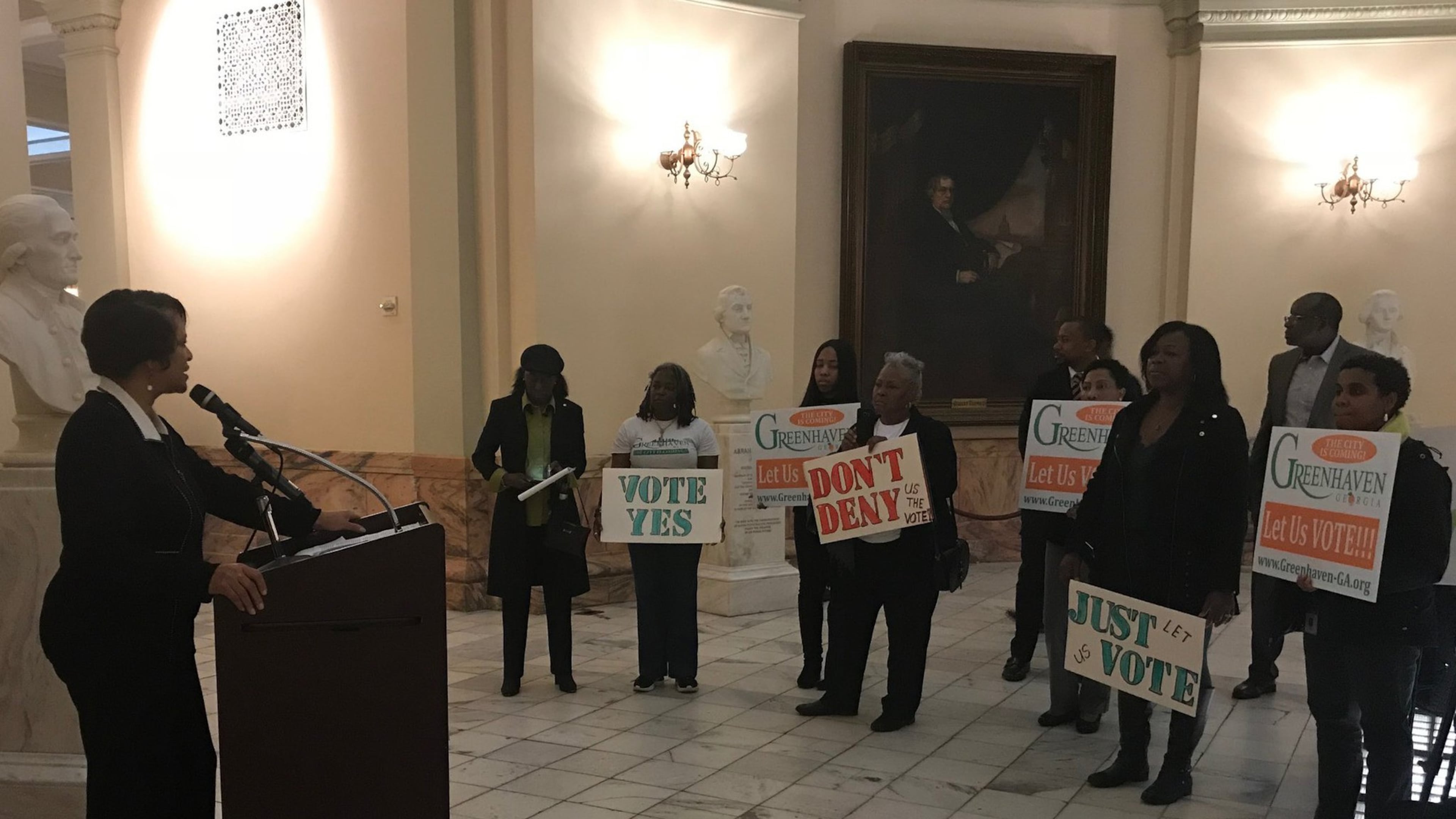 Kathryn Rice speaks in favor of creating the city of Greenhaven as supporters hold signs during a press conference at the State Capitol on Feb. 15, 2018.