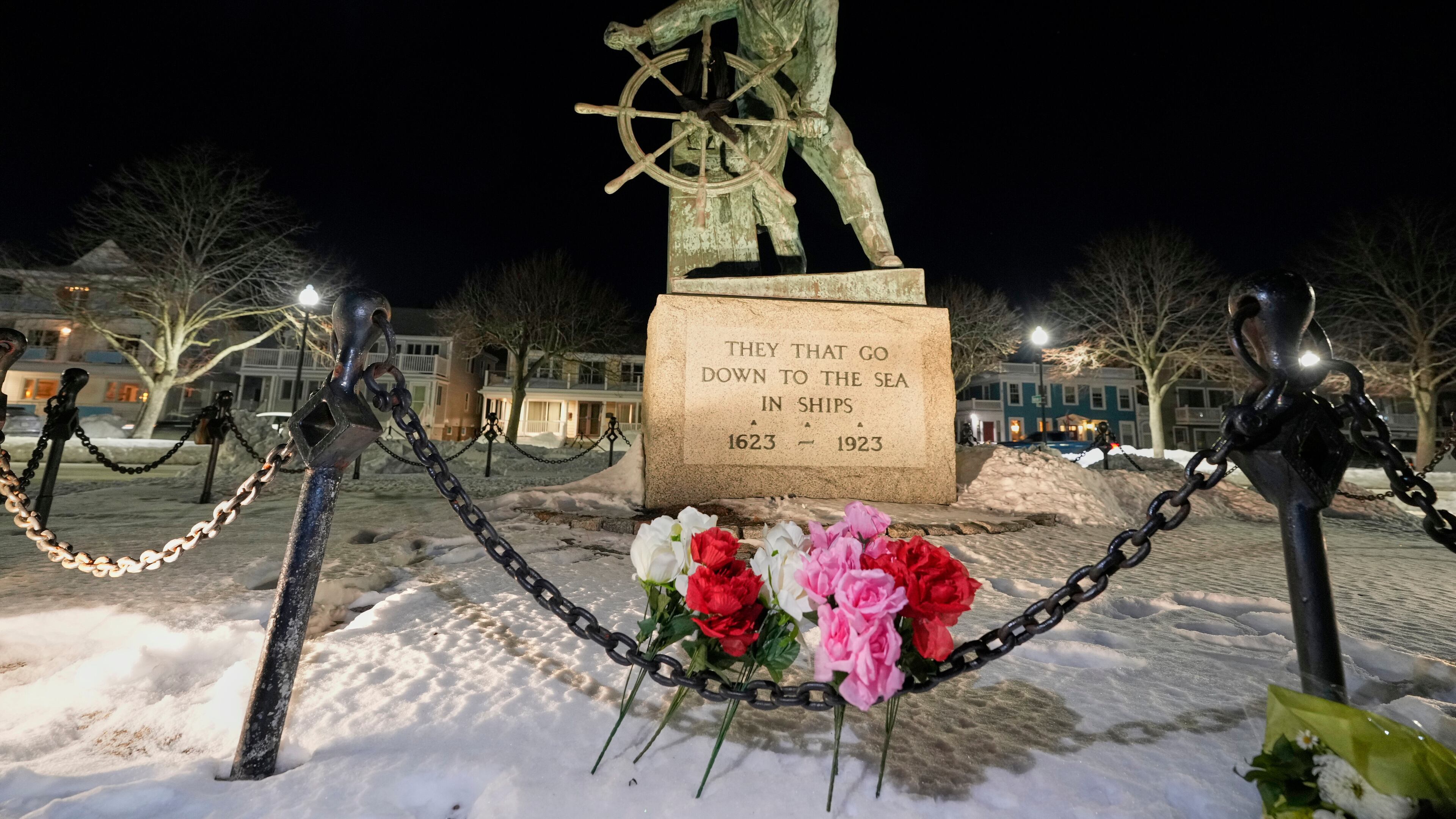 Flowers are seen placed at the Gloucester Fisherman's Memorial in Gloucester, Mass., after a fishing boat from port city went missing off the coast of Massachusetts with multiple people on board, Friday, Jan. 30, 2026. (AP Photo/Robert F. Bukaty)