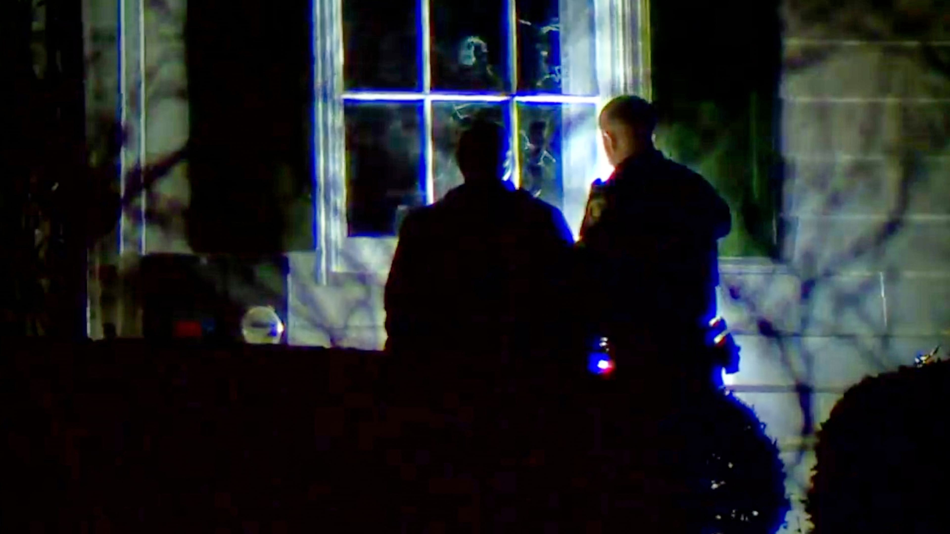 In this image taken from WCPO 9 News video shows officials inspecting broken windows and other property damage at Vice President JD Vance's Ohio home in eastern Cincinnati, Ohio, Monday, Jan. 5, 2026. (WCPO 9 News via AP)