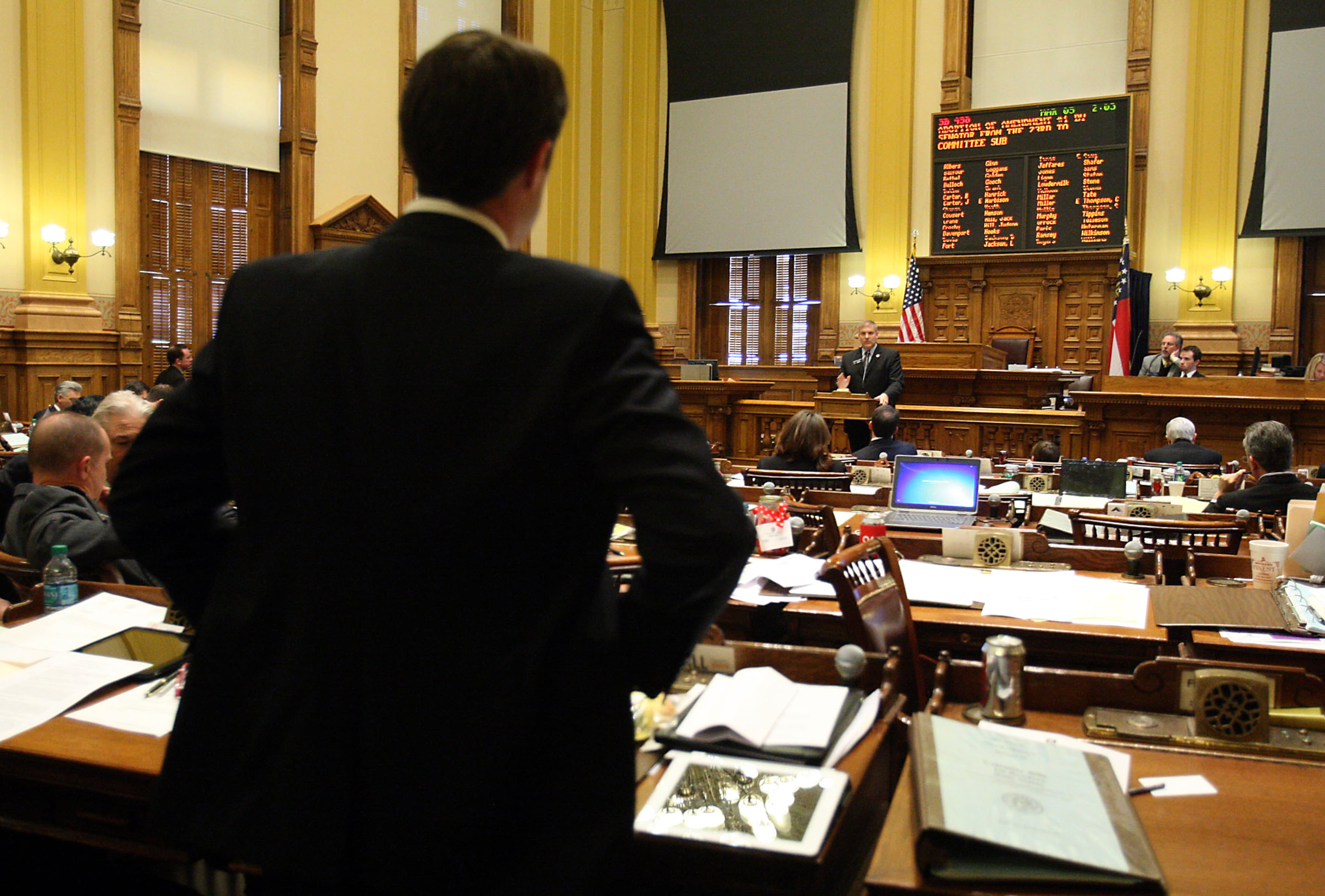 Sen. Jason Carter, D-Decatur, left, asks a question to Sen. Barry Loudermilk, R-Cassville, during a discussion about Senate Bill 458, which would ban illegal immigrants from attending all public colleges, during legislative day 29 at the State Capitol on March 5, 2012.