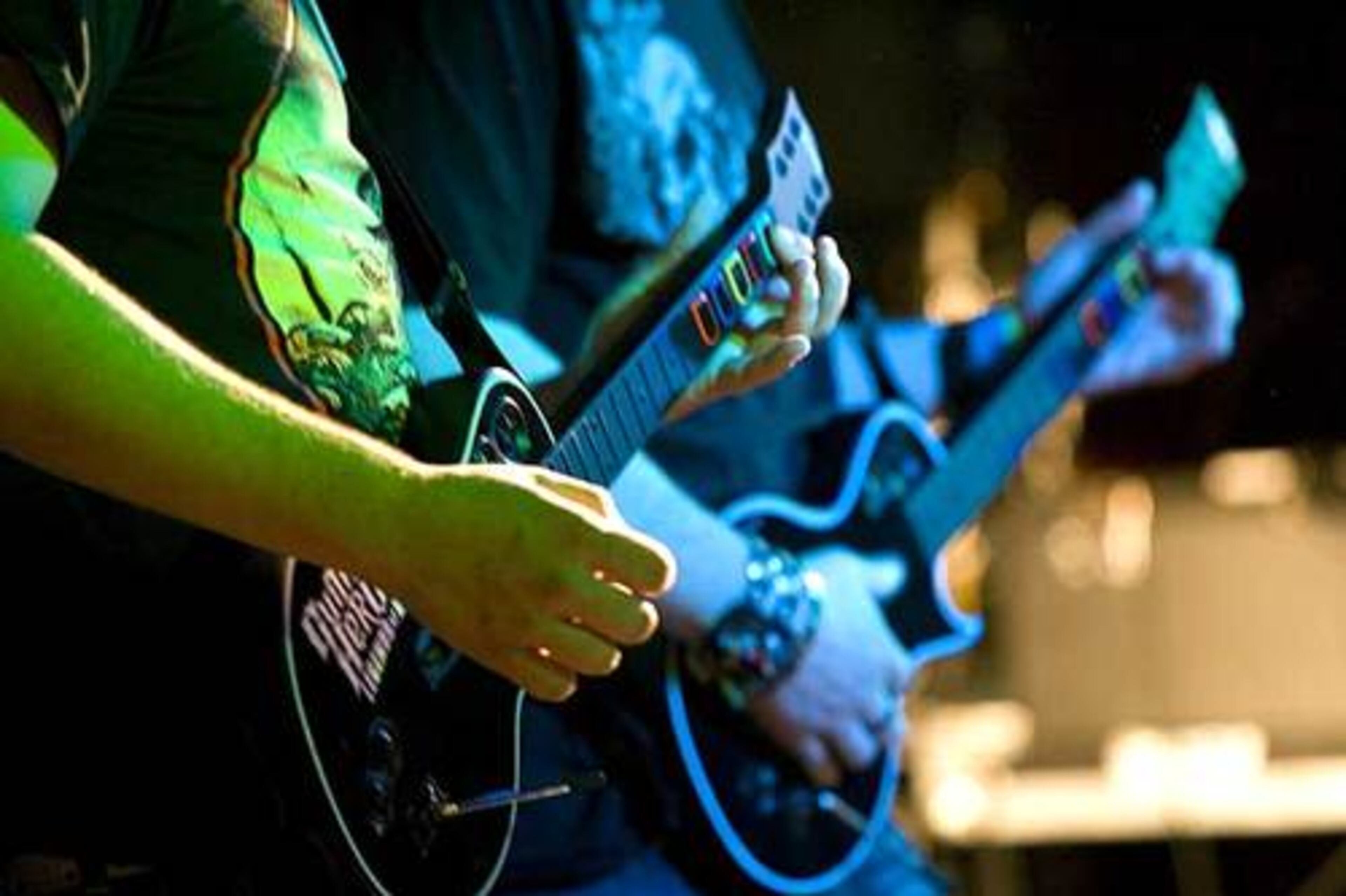 Contestants play their game instruments during the Guitar Hero III Championship Play-Off . Rock band Alter Bridge members performed judging duties and played a live show after the contest.