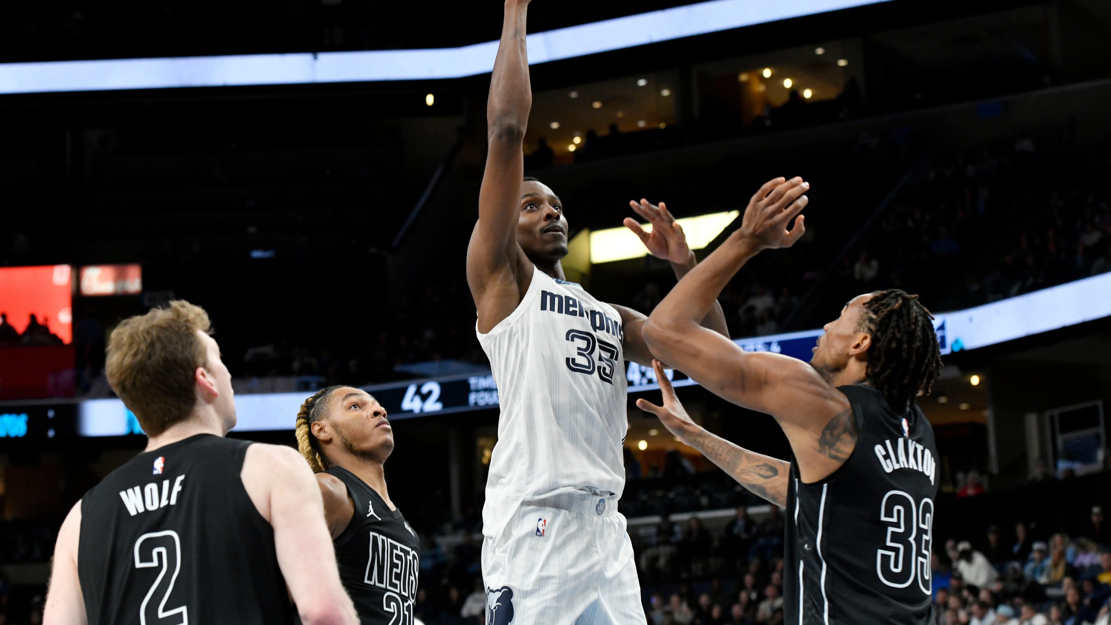 Then-Grizzlies center Christian Koloko (center) shoots over Nets players Danny Wolf (from left), Noah Clowney and Nic Claxton on Sunday, Jan. 11, 2026, in Memphis, Tenn. Koloko has had quite the welcome to Atlanta. (Brandon Dill/AP)