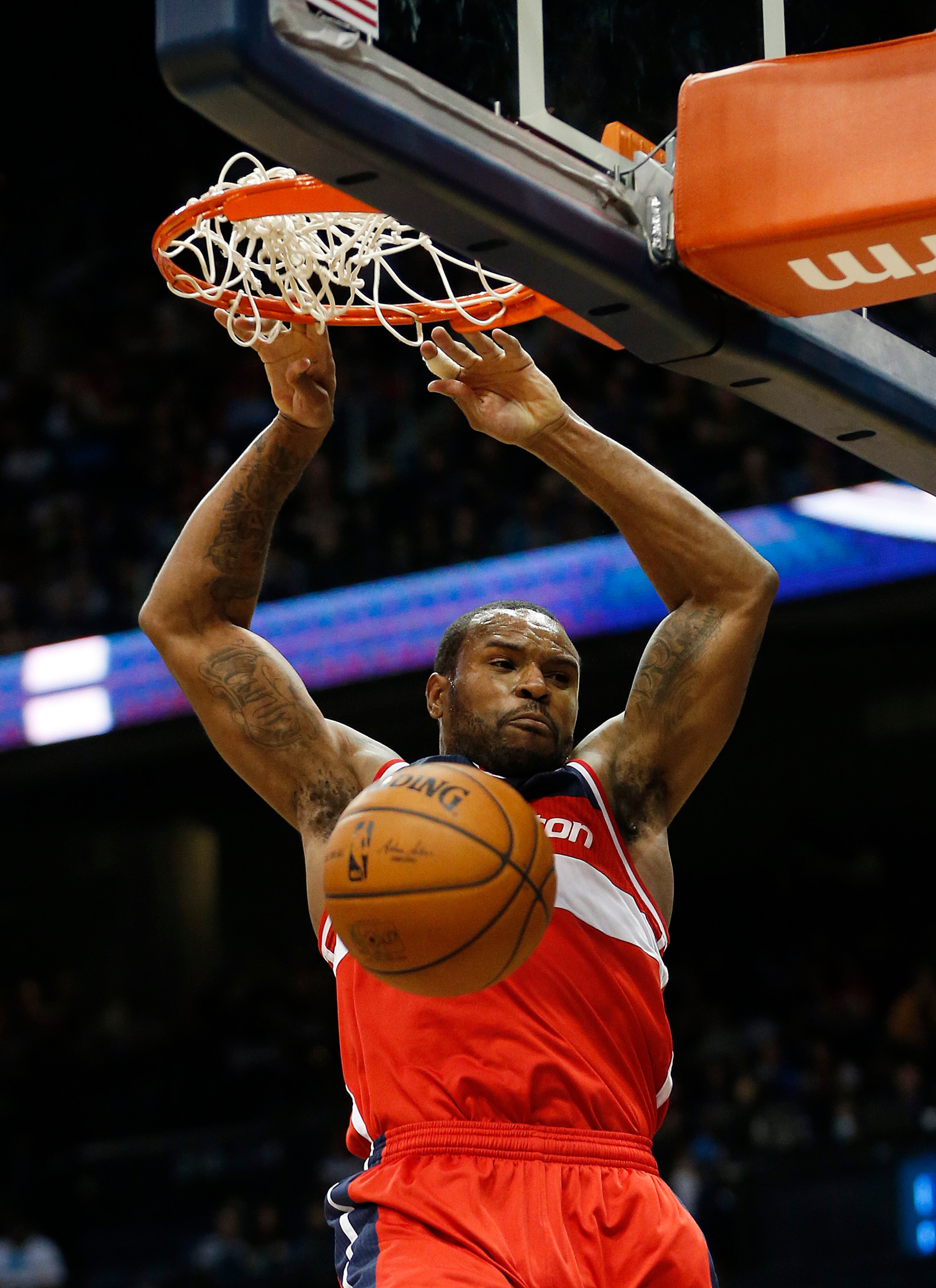 Washington Wizards forward Trevor Booker scores against the Atlanta Hawks in the second half of an NBA basketball basketball game Wednesday, Feb. 19, 2014, in Atlanta. Washington won 114-97. (AP Photo/John Bazemore)