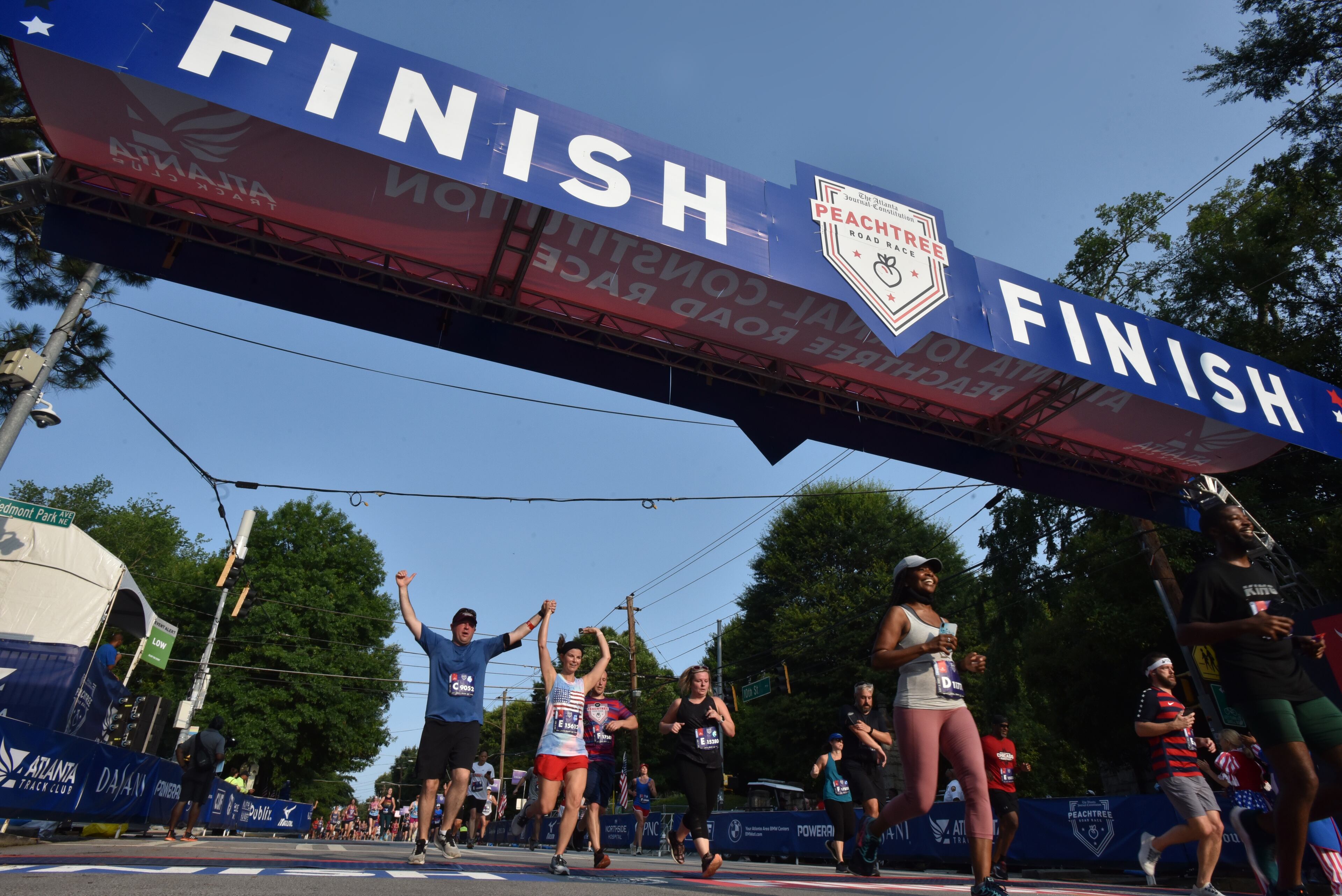July 3, 2021 Atlanta - Runners make their way to the finish line during the first day of 2021 Atlanta Journal-Constitution Peachtree Road Race on Saturday, July 3, 2021. (Hyosub Shin / Hyosub.Shin@ajc.com)