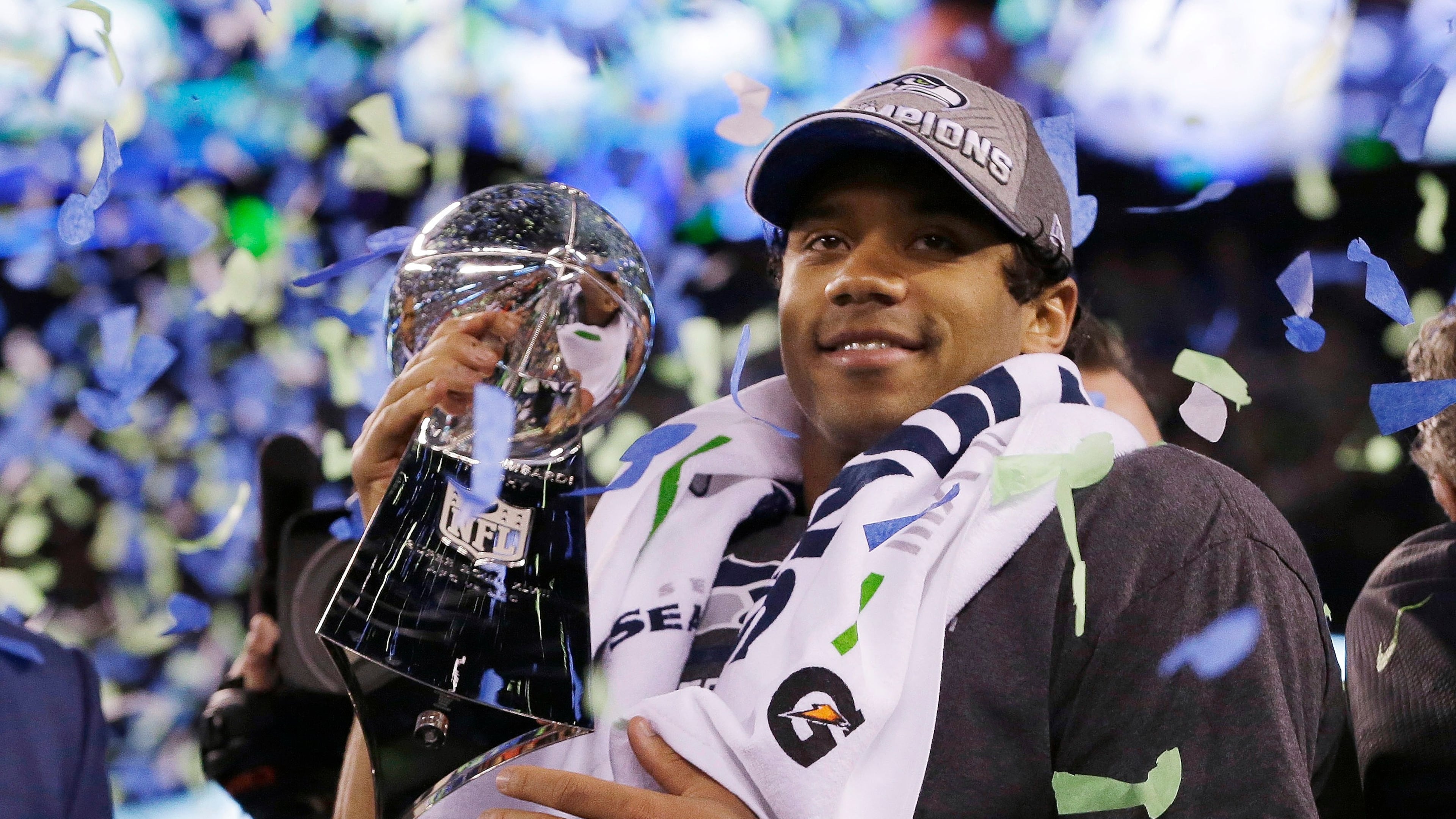 FILE - Seattle Seahawks' quarterback Russell Wilson holds the Lombardi Trophy after the NFL Super Bowl XLVIII football game, Feb. 2, 2014, in East Rutherford, N.J. (AP Photo/Julio Cortez, File)