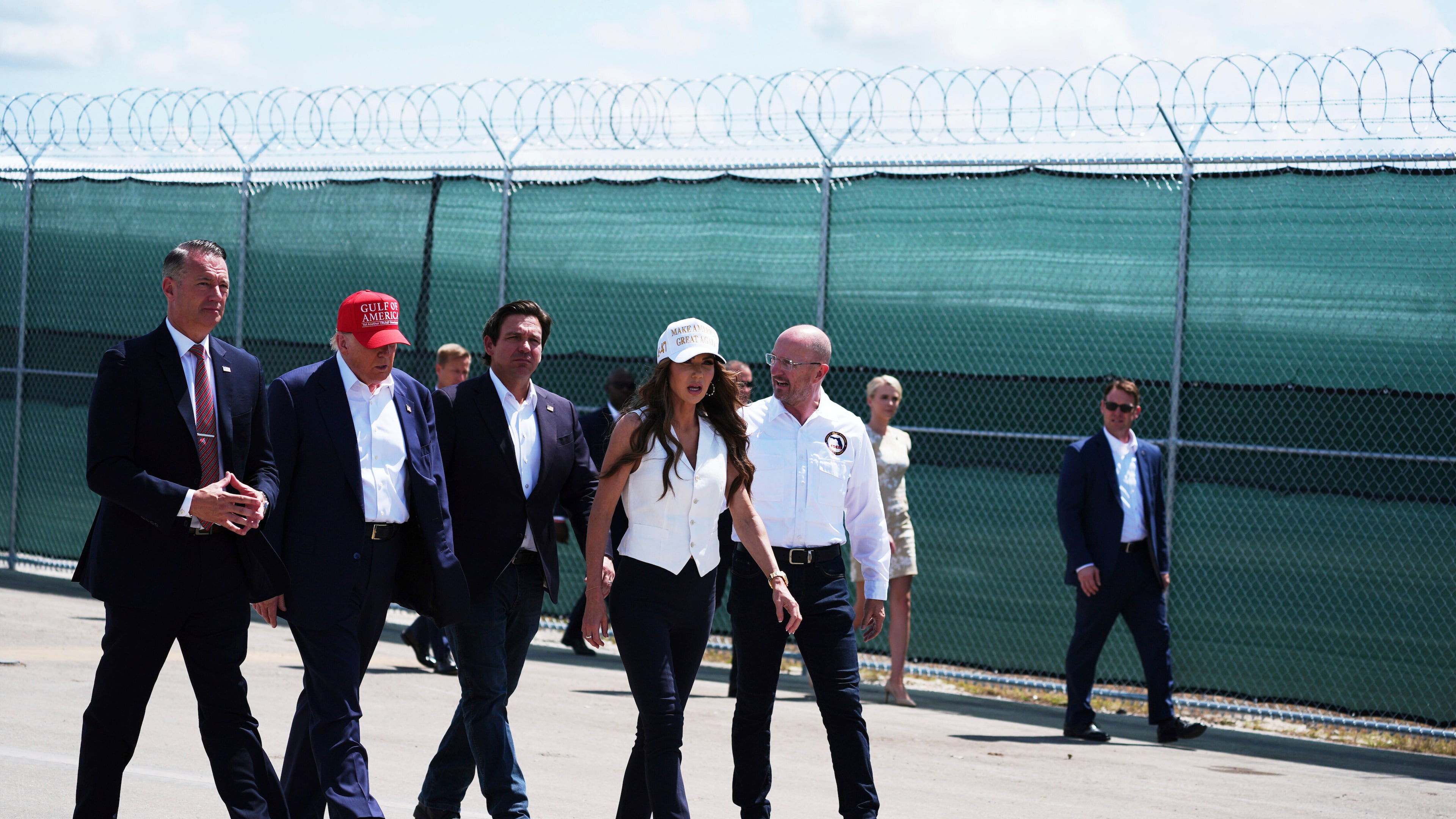 FILE - President Donald Trump, Gov. Ron DeSantis, R-Fla., and Homeland Security Secretary Kristi Noem and others tour "Alligator Alcatraz," a new migrant detention facility at Dade-Collier Training and Transition facility, July 1, 2025, in Ochopee, Fla. (AP Photo/Evan Vucci, File)