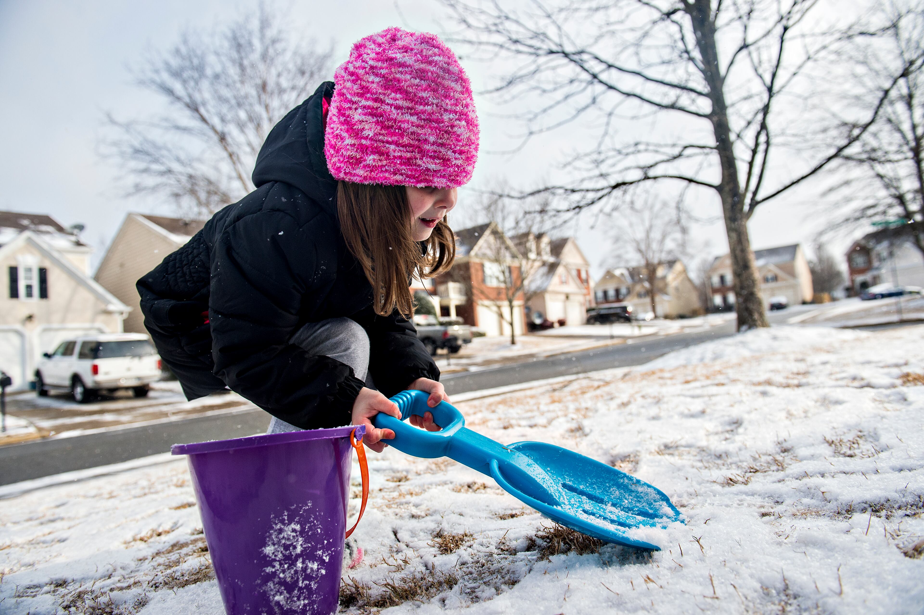 Ansley Olver shovels snow into a bucket at her home in Cumming on Saturday, January 23, 2016. Freezing rain, sleet and snow fell through Friday evening around different parts of the metro area and below freezing temperatures kept the snow around through the morning hours and in to the afternoon on Saturday. JONATHAN PHILLIPS / SPECIAL