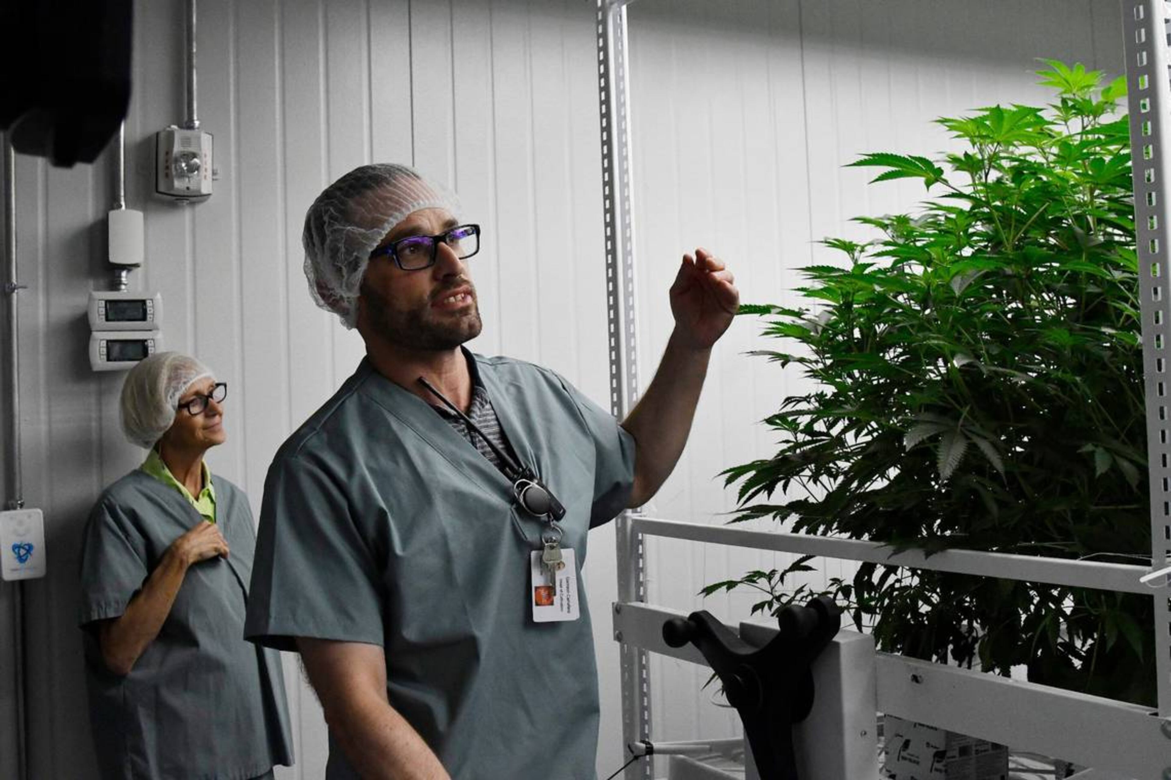 Garrison Carrafield (right) shares information about the cannabis plants with tour participants as Mary Adams (left) listens on Wednesday, May 29, 2024, at the Fine Fettle cannabis cultivation and extraction facility in Macon, Georgia. (Photo Courtesy of Katie Tucker)