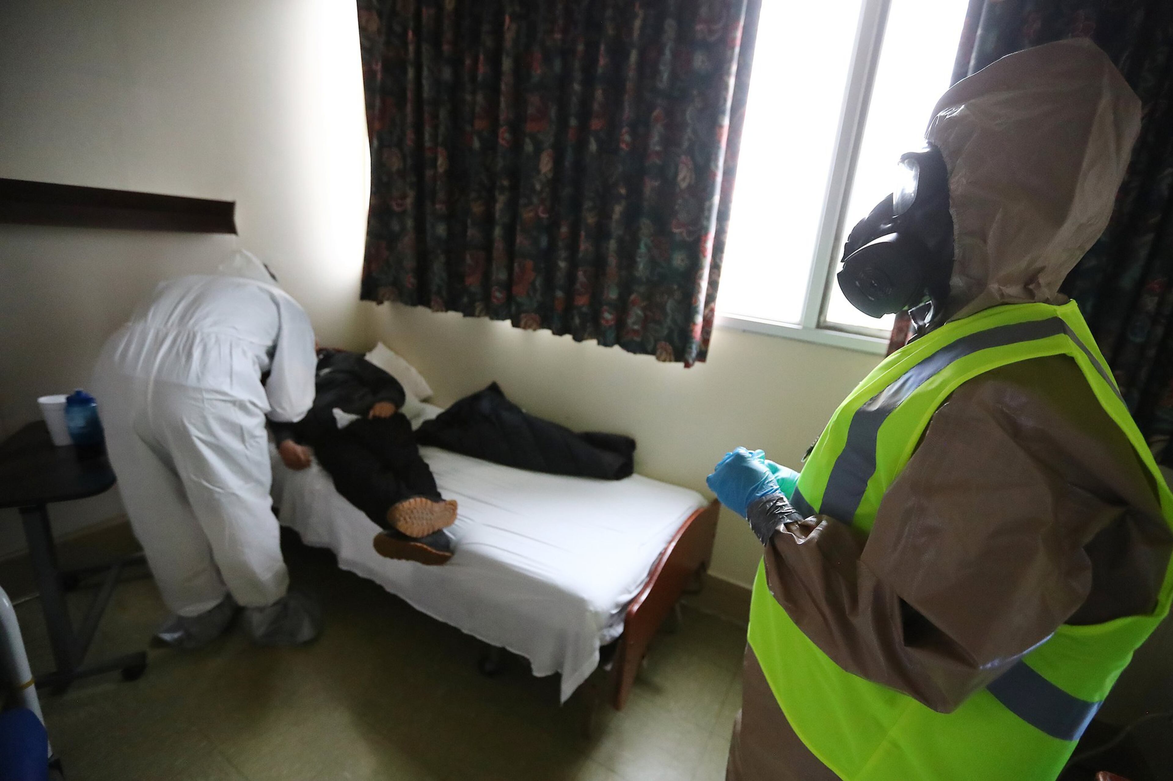 Pfc. Cierra Williams, right, assists Dr. Stephen Smith in testing residents for COVID-19 at Legacy Transitional Care and Rehabilitation in Atlanta Sunday, April 19, 2020. Curtis Compton ccompton@ajc.com
