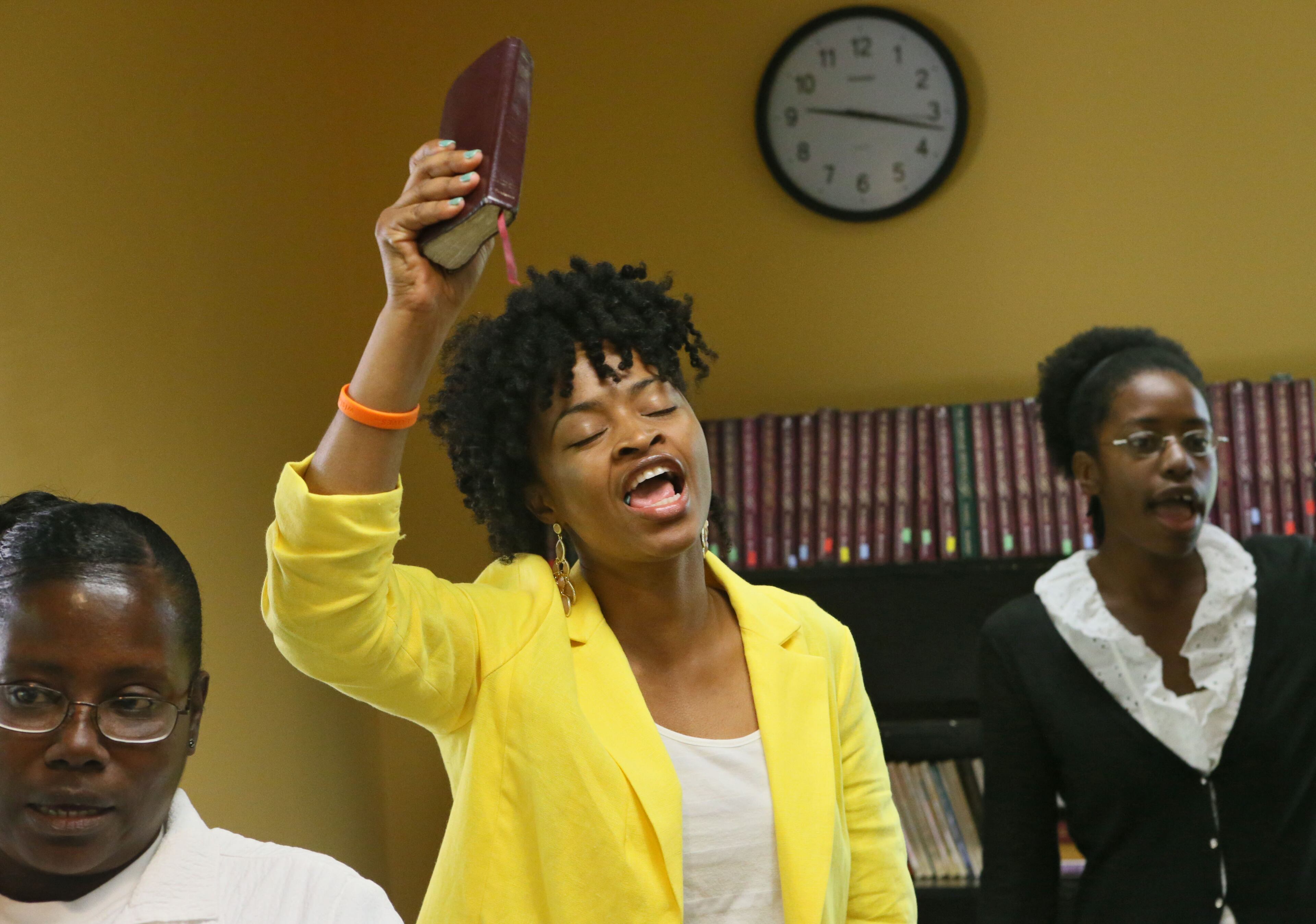 Iraqi war veteran Sonia Simon brandishes her Bible (she calls it her sword) in the daily morning prayer session at Every Woman Works, a nonprofit organization in Sandy Springs that helps women hone the skills they need to live an independent life.