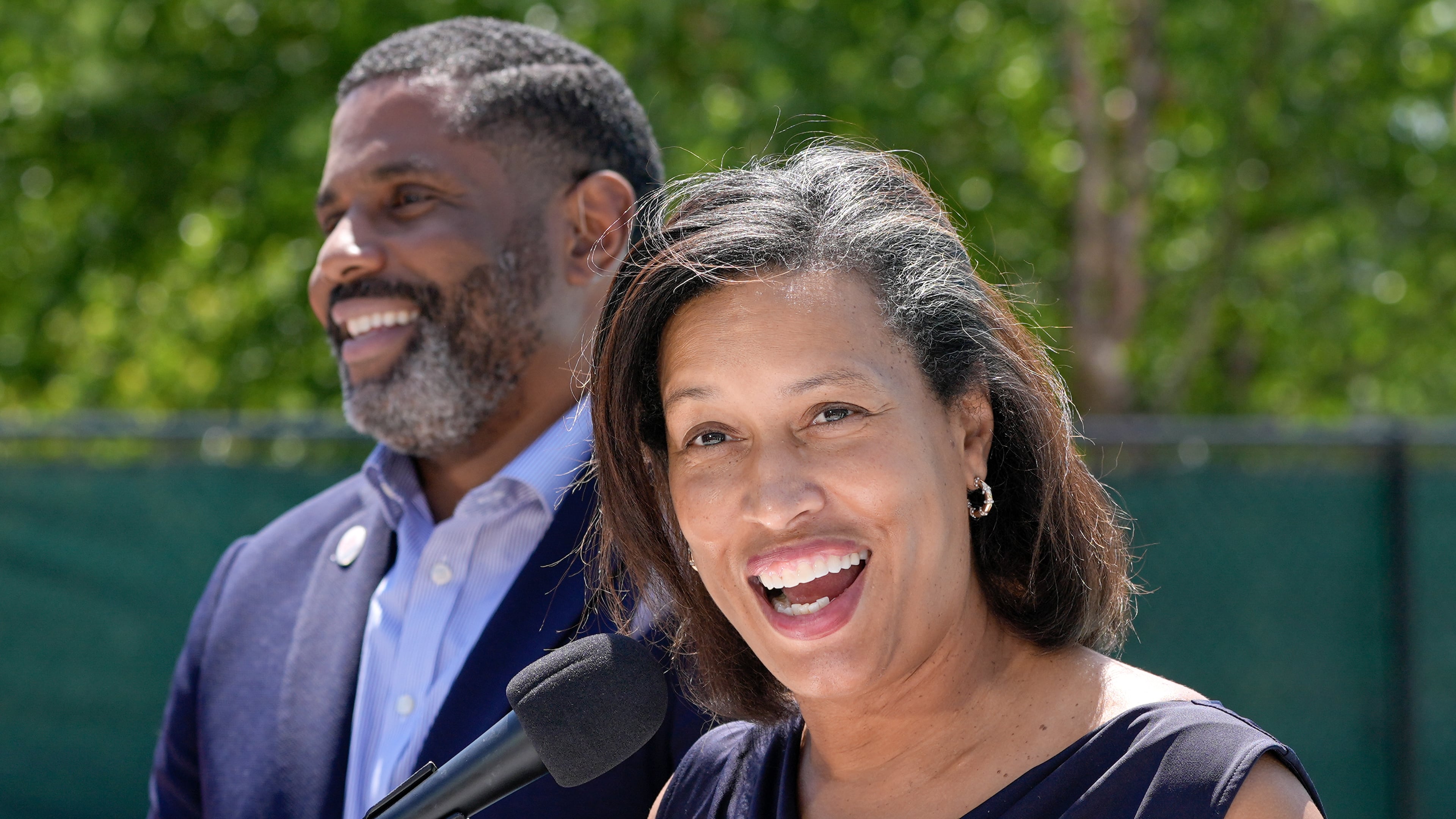 District of Columbia Mayor Muriel Bowser, right, speaks as Delano Hunter, director of the DC Department of General Services, left, listens during the opening of the newly renovated outdoor pool at the Rosedale Recreation Center, Thursday, July 23, 2026, in Washington. (AP Photo/Mariam Zuhaib)