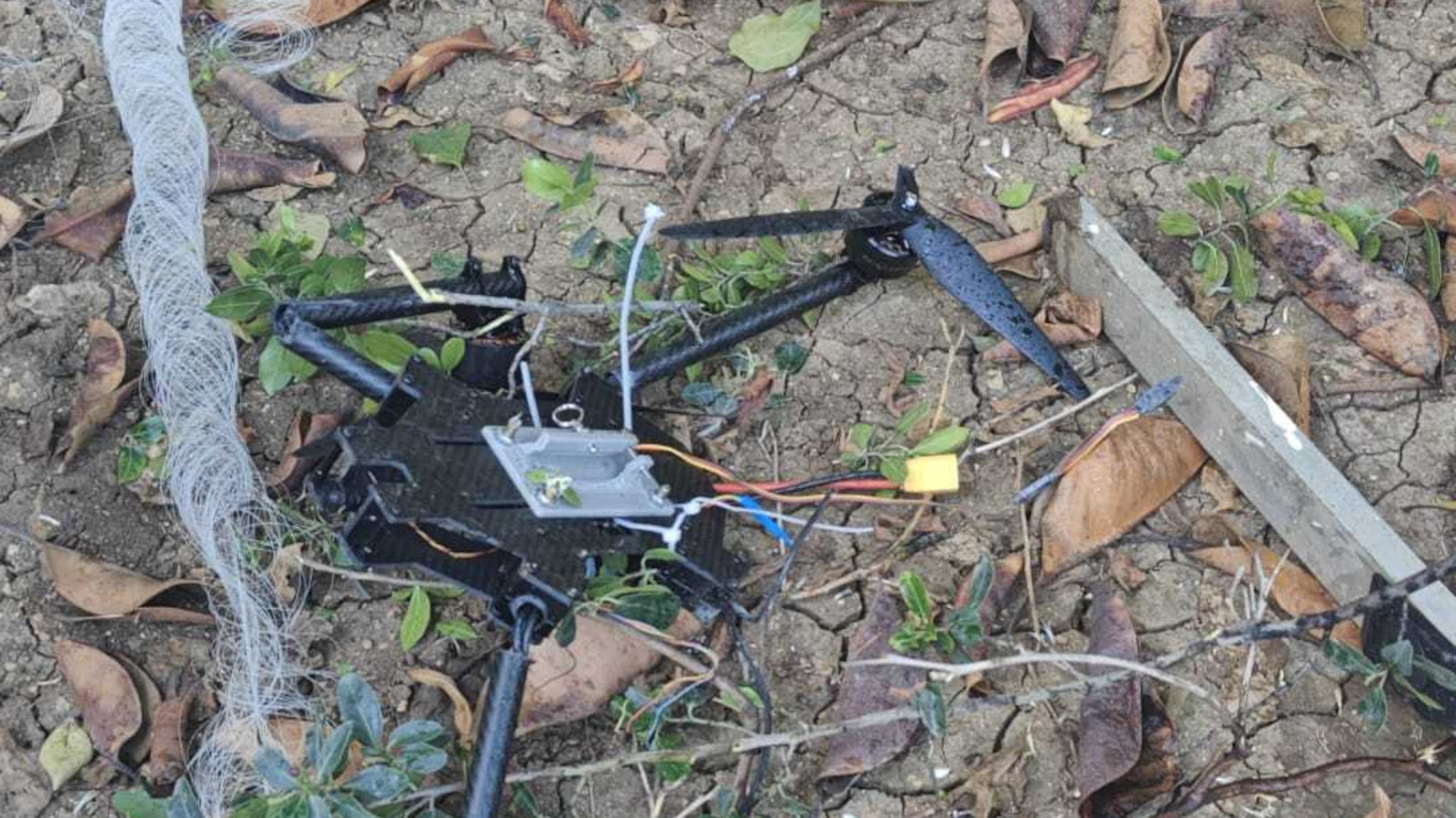 This photo provided by Zevik Glidai shows a fiber-optic drone surrounded by cables lying in the backyard of his home in Kiryat Shmona, Israel, after being brought over the border from Lebanon, Monday, April 13, 2026. (Zevik Glidai via AP)