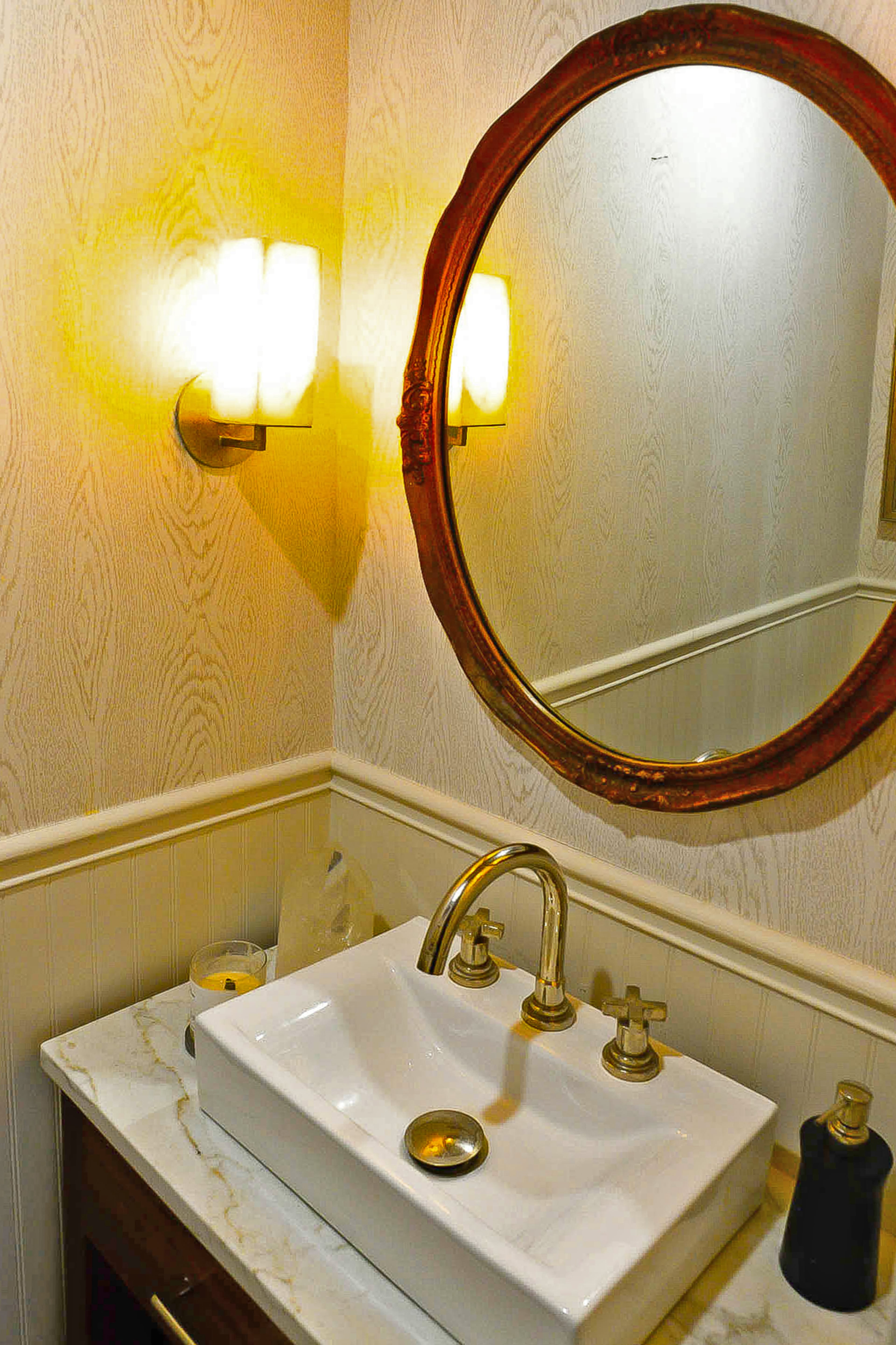 The guest bathroom's mirror holds special meaning for the homeowner, who purchased it in her teens. She told her parents, "Someday I'll put this in my house."