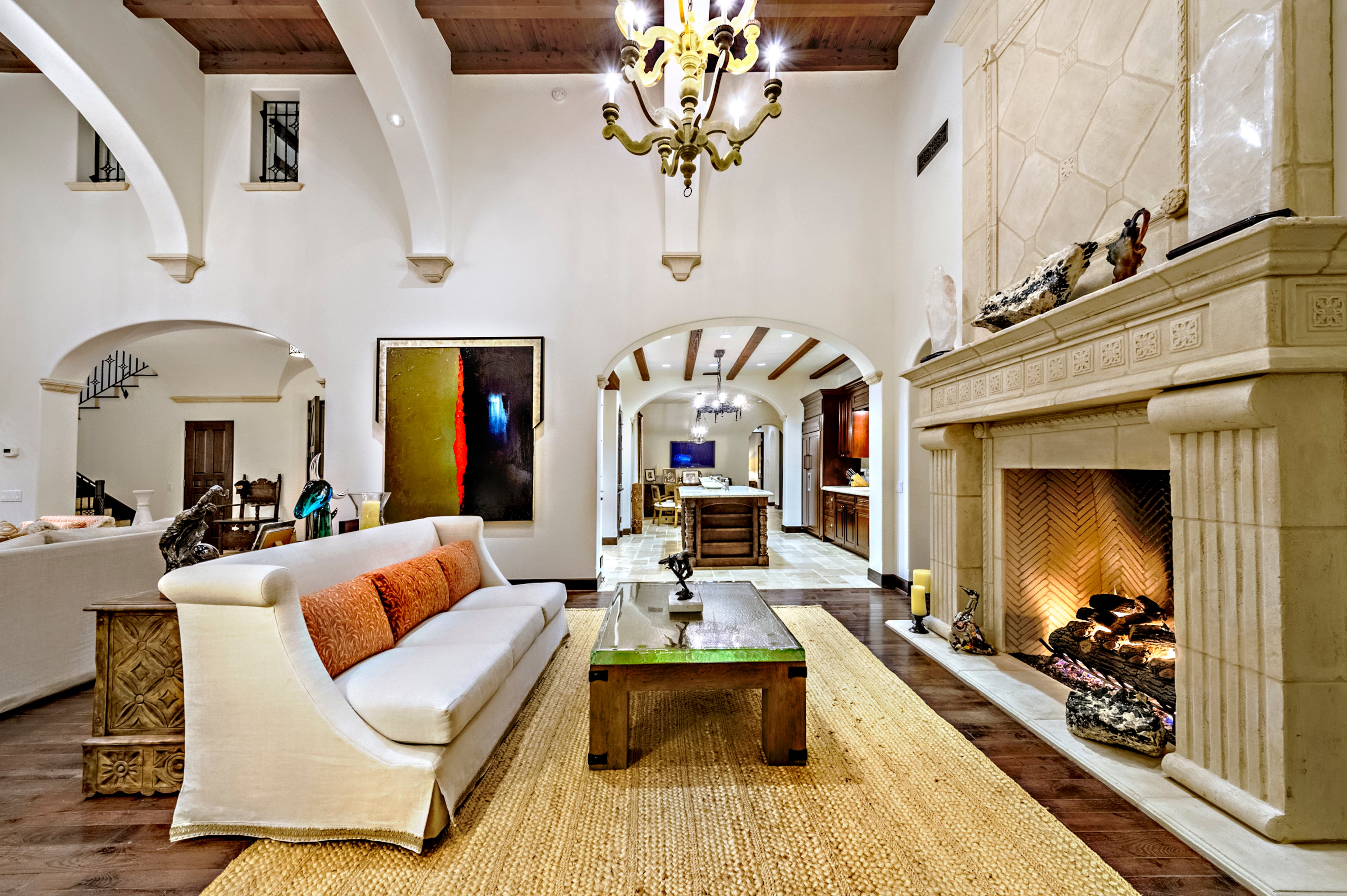 A stone fireplace is the focal point on one wall of the living room. Rocky star and all-around action movie legend Sylvester Stallone has put his desert home in a gated La Quinta, Calif., community up for sale at $4.2 million. The 5,173-square-foot, four-bedroom, 4.5-bathroom home features details such as arched doorways, exposed beams, and plenty of space to hang his paintings, since he’s not just an actor—he’s an artist, too. Listing courtesy of Josh Reef, Hurwitz James Company