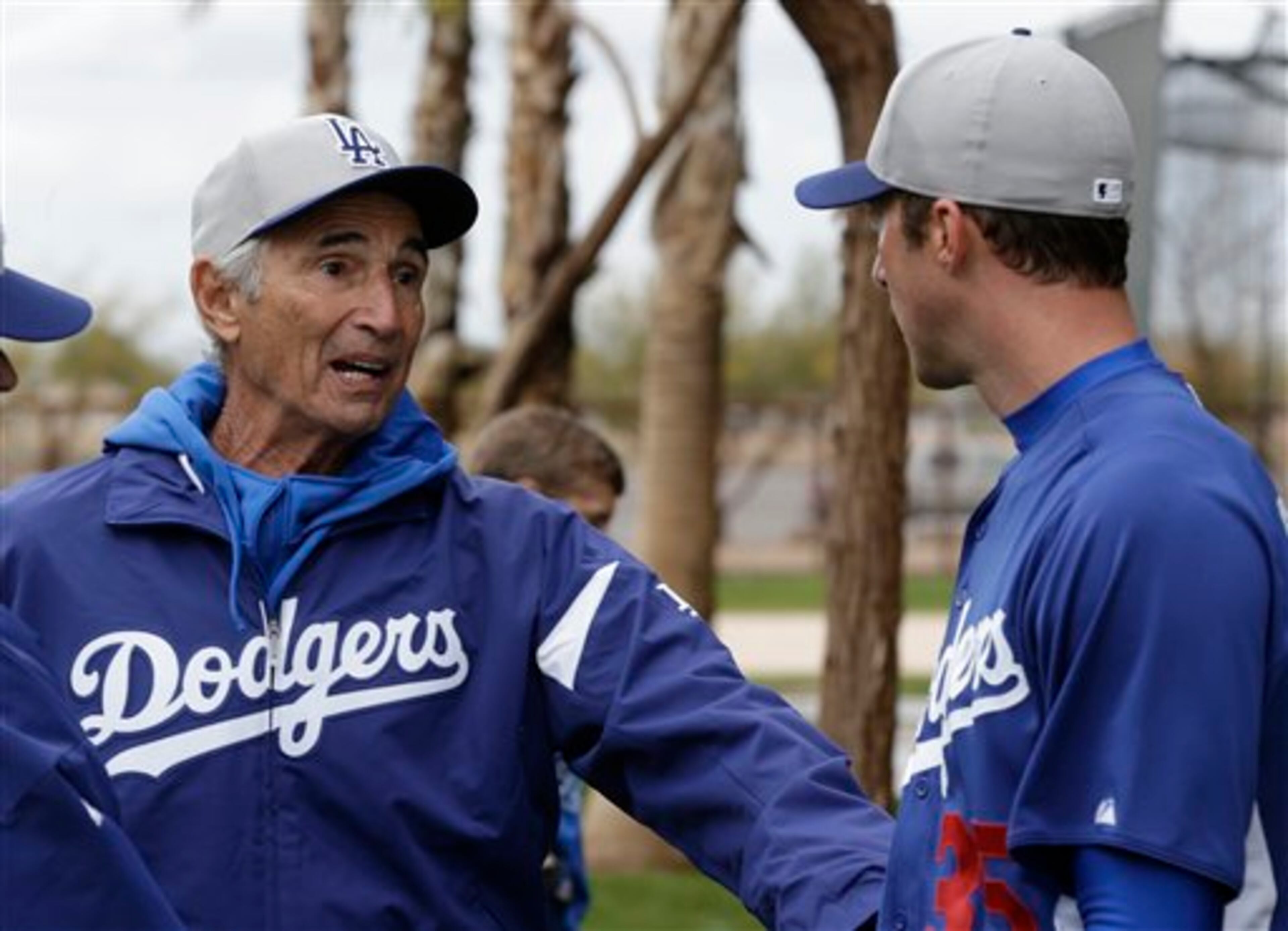 Los Angeles Dodgers Hall of Fame pitcher Sandy Koufax, left, talks with pitcher Chris Capuano during spring training baseball in Phoenix, Wednesday, Feb. 20, 2013. (AP Photo/Paul Sancya)