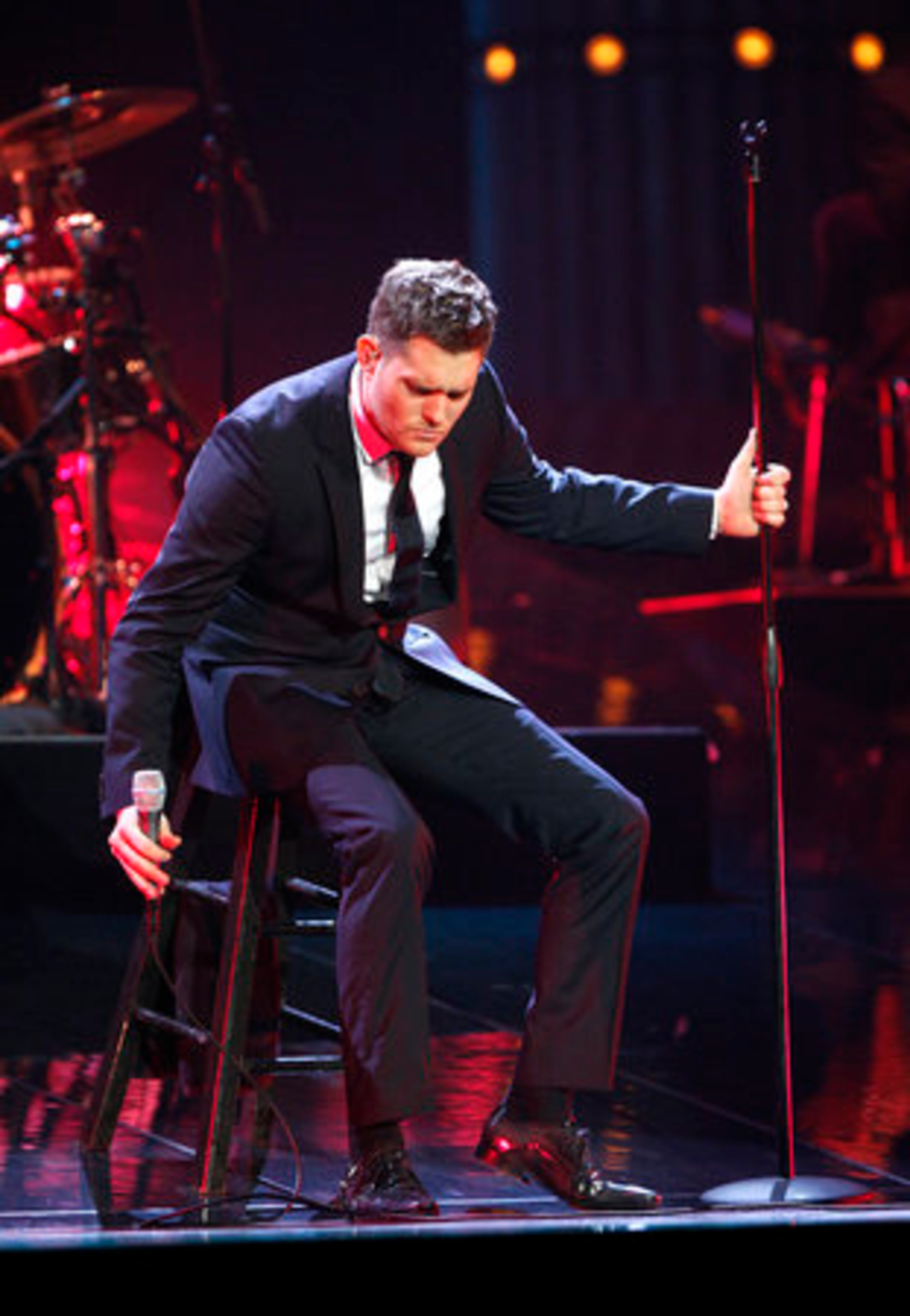 Michael Bubl sits on a stool as he begins singing a medley.