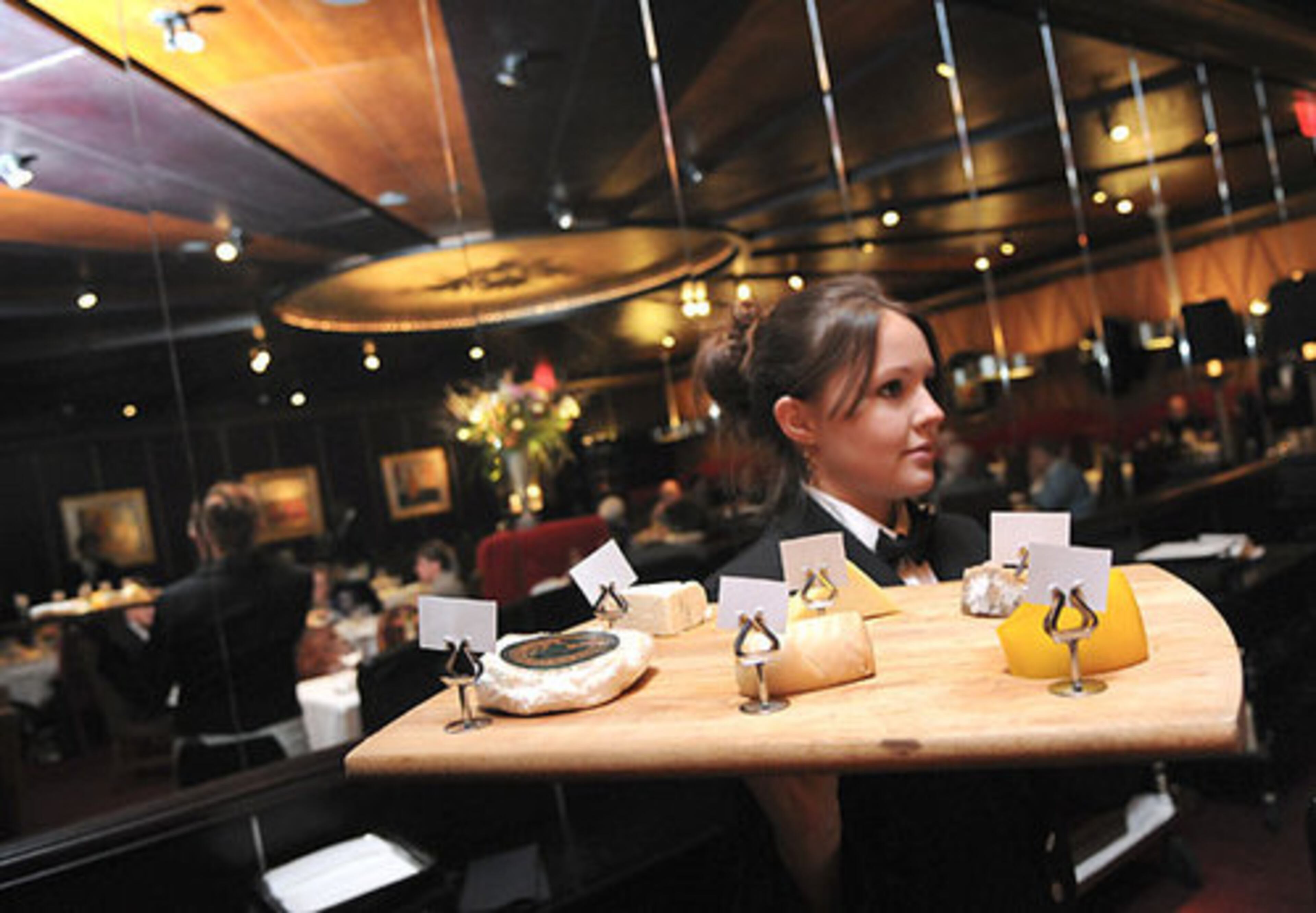 Pano's and Paul's restaurant in Buckhead will close Feb. 28, 14 days later than owners originally had planned to shut the doors. Seen here on a recent night, Jessica Vincent, carrying the cheese tray to a table, has waited tables at Pano's and Paul's for four years.