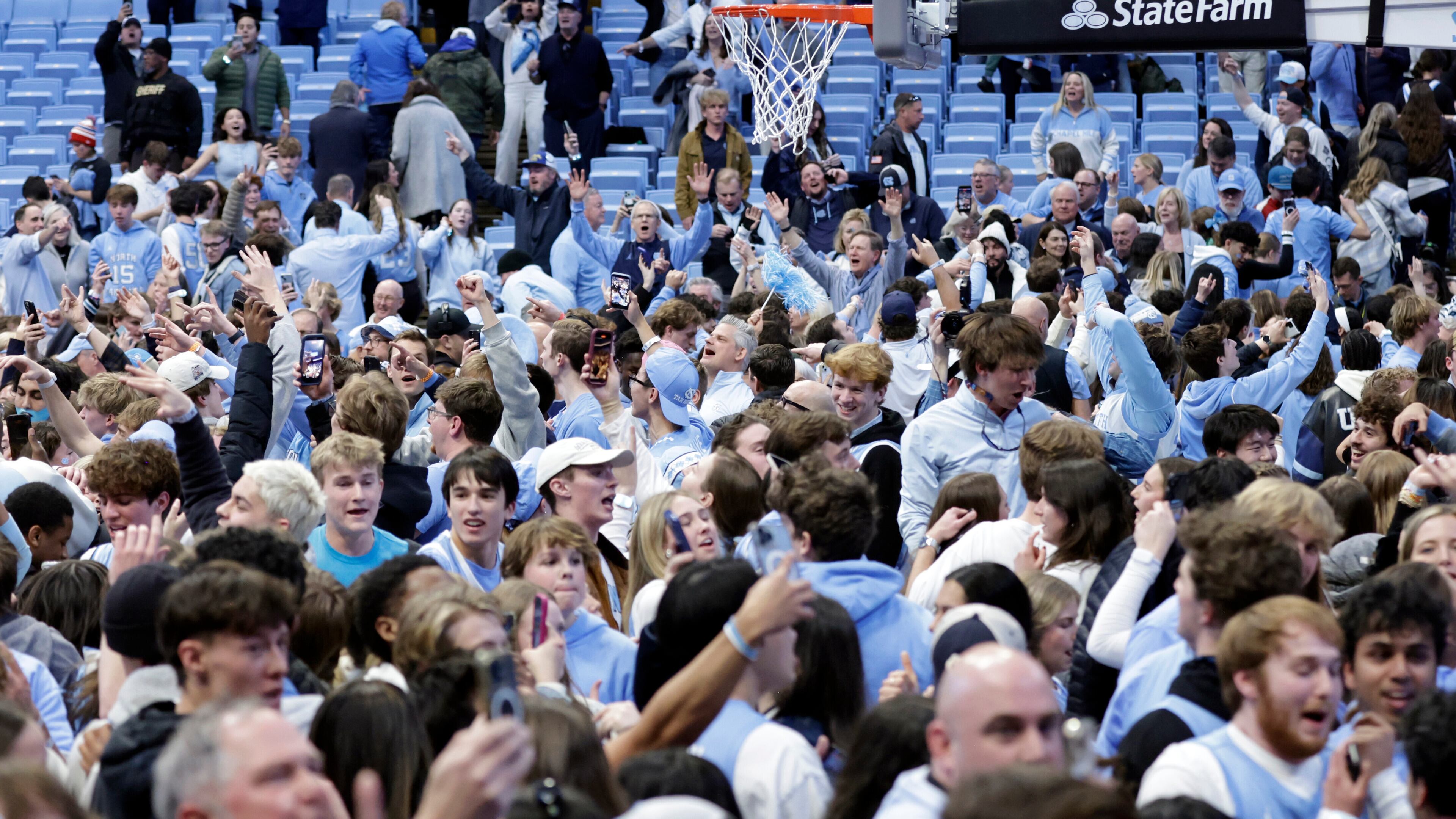 North Carolina fans take the floor and celebrate after the team defeated Duke in the final seconds of an NCAA college basketball game Saturday, Feb. 7, 2026, in Chapel Hill, N.C. (AP Photo/Chris Seward)