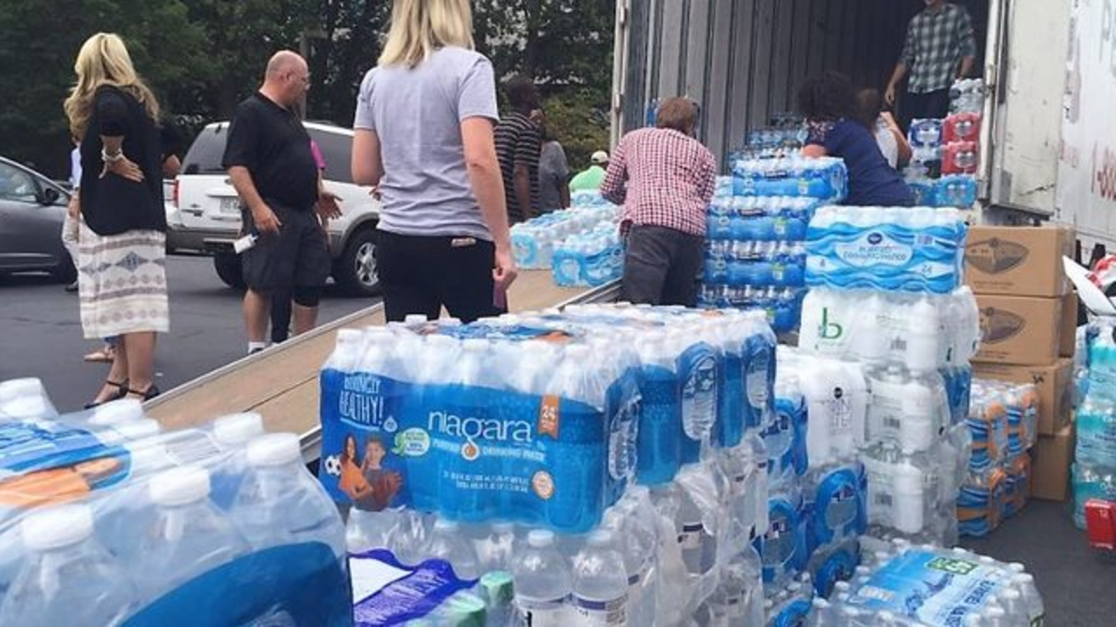 Volunteers prepare packages of bottled water to be delivered from Atlanta to Houston after Hurricane Harvey in 2017.